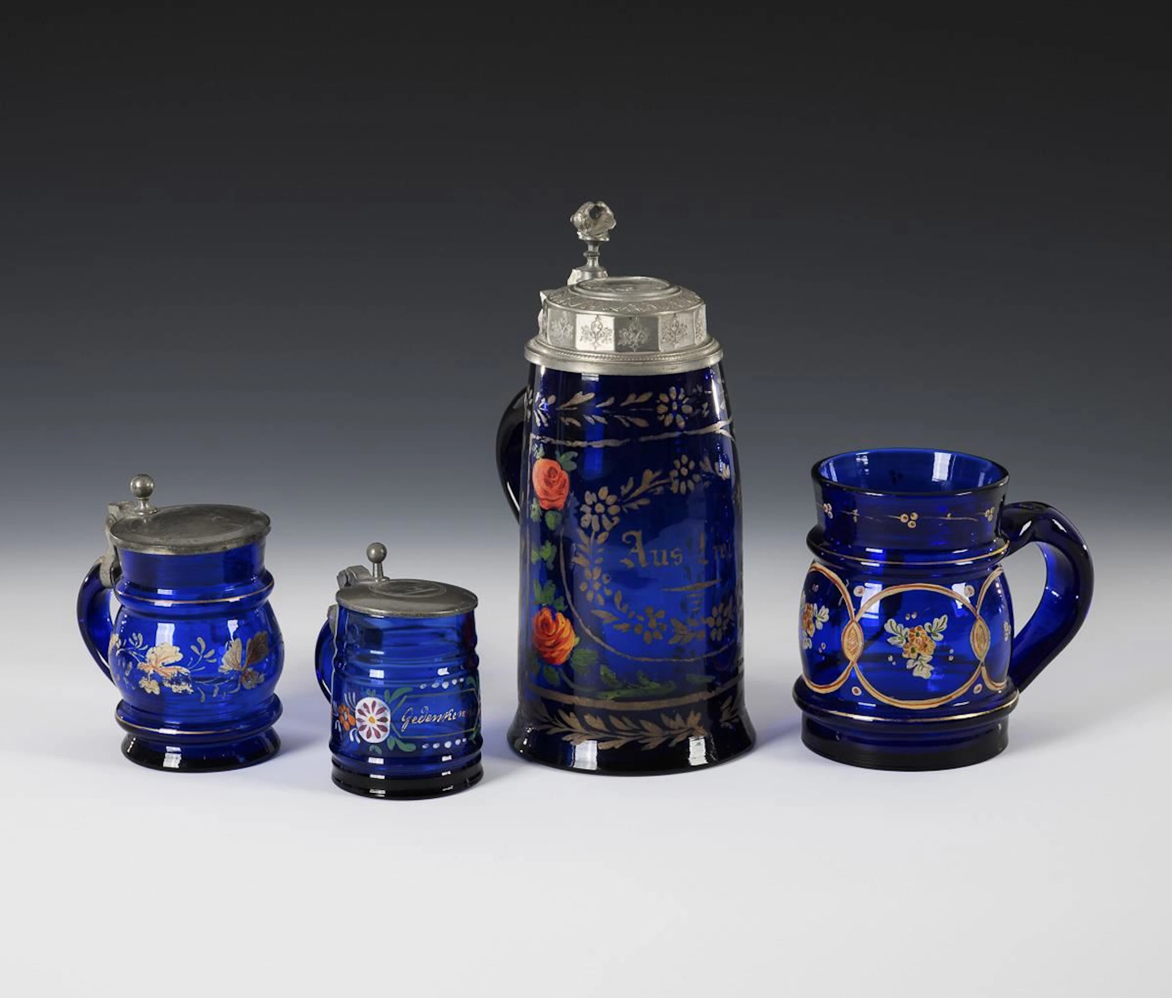 4 cobalt-blue beer mugs.