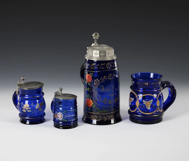 4 cobalt-blue beer mugs.