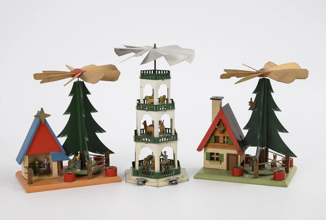 Small tin pyramid and 2 wooden pyramids with a Christmas tree.