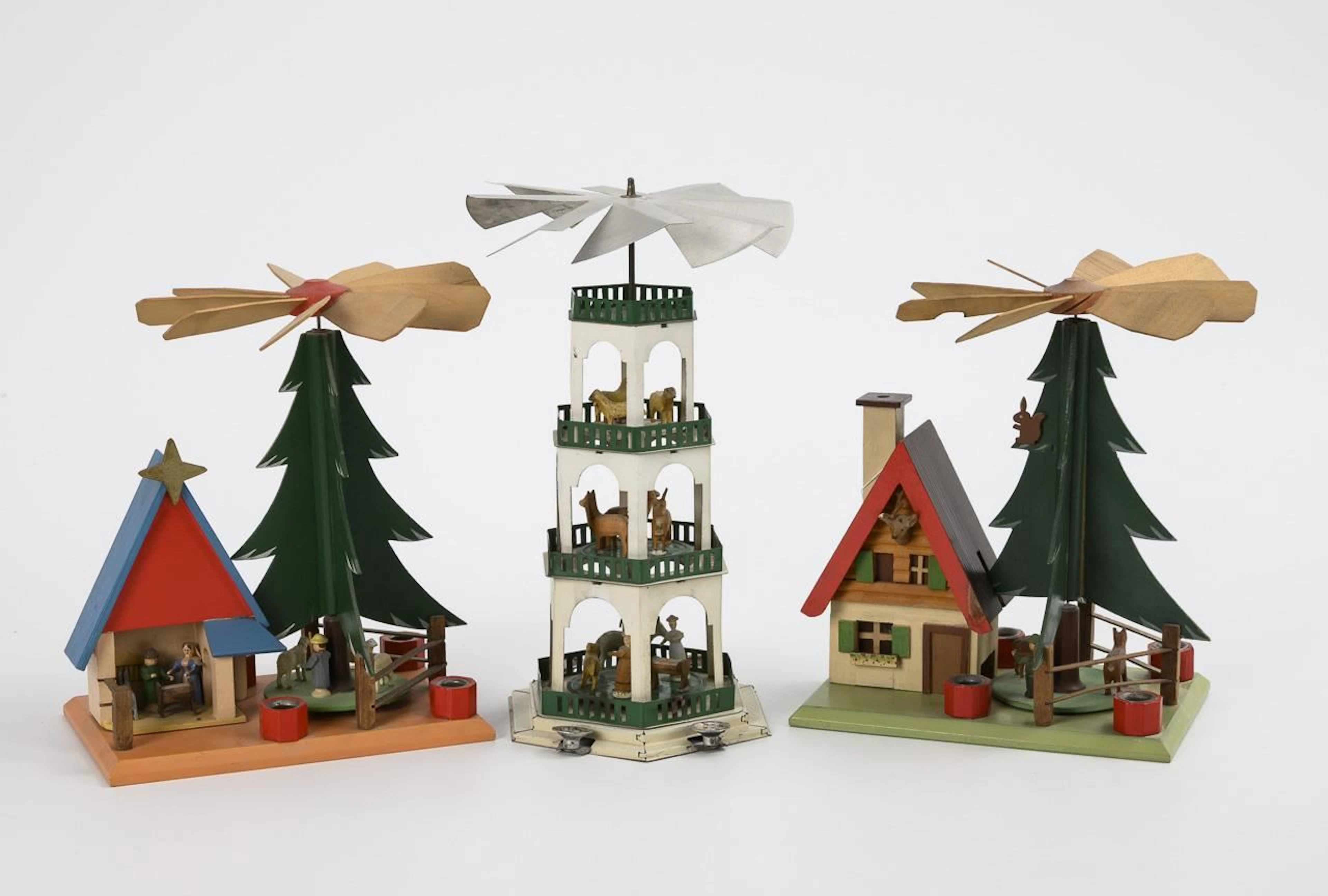 Small tin pyramid and 2 wooden pyramids with a Christmas tree.