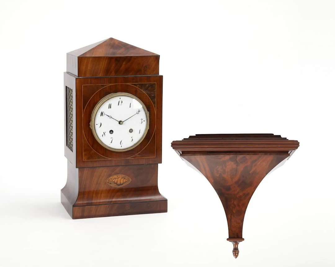 Bracket clock on a console with quarter-hour chimes.
