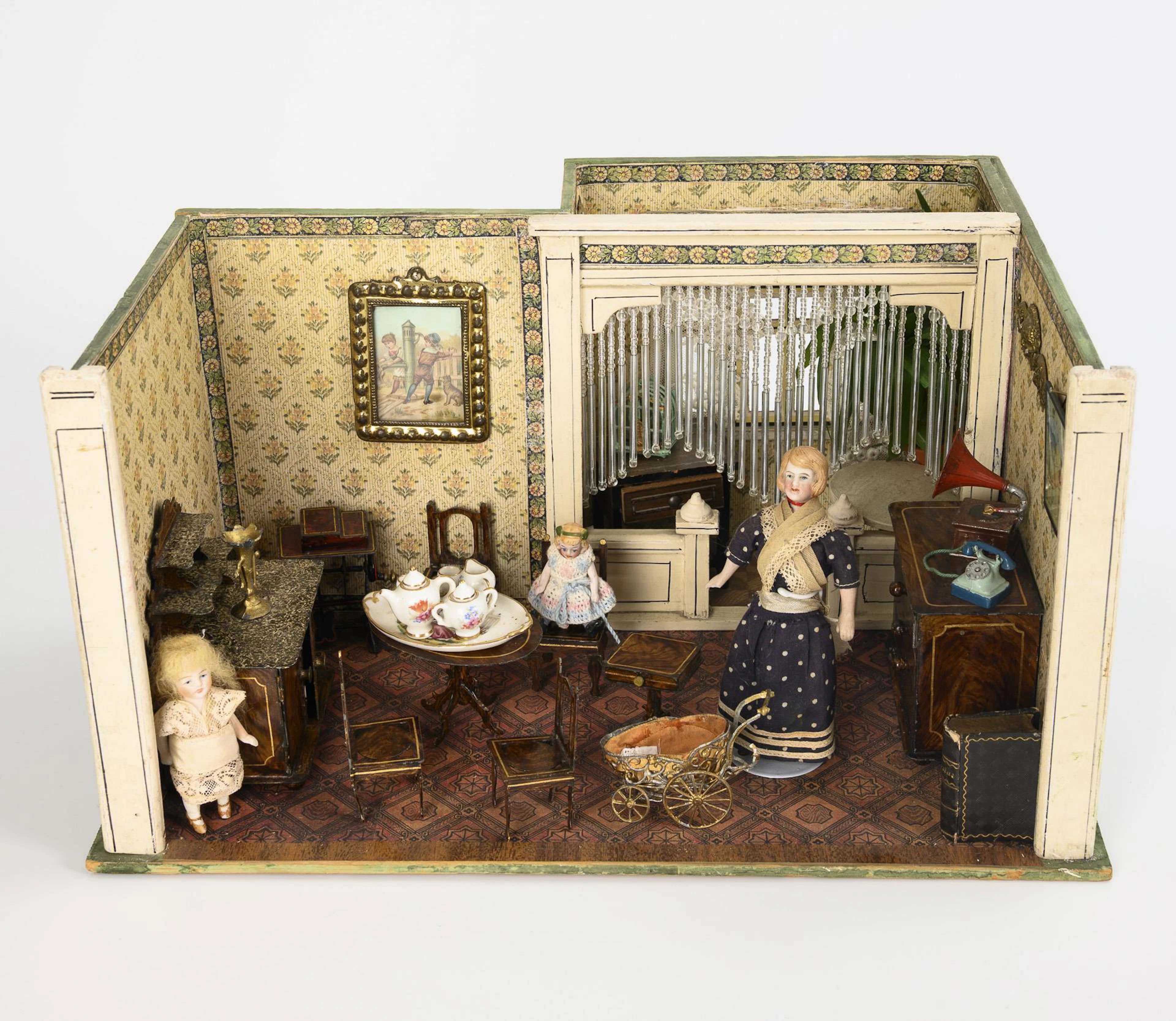 Small doll's house with bay window and tin furniture.