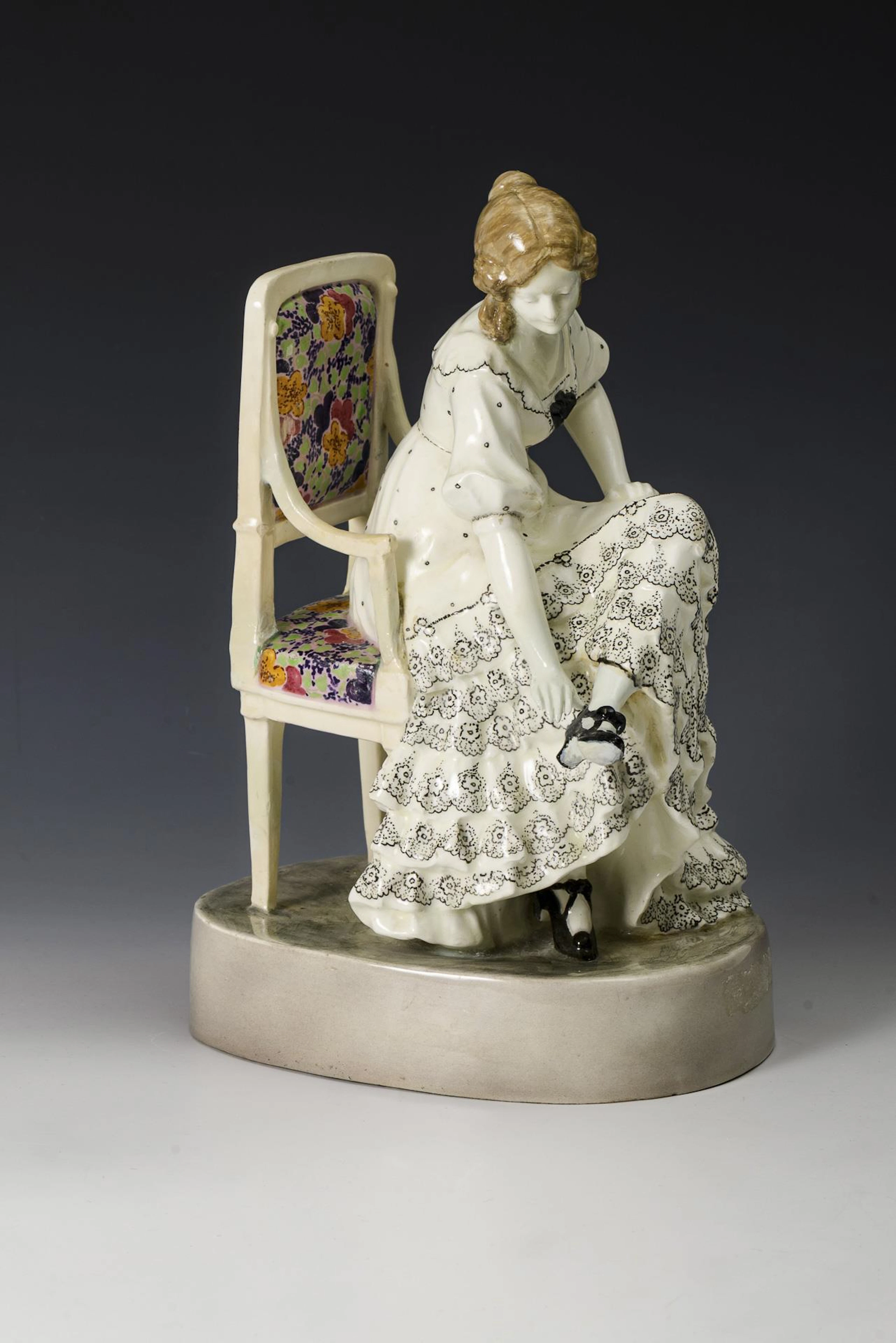 Art Nouveau figure "Sitting dancer, taking off a shoe". Vienna manufactory