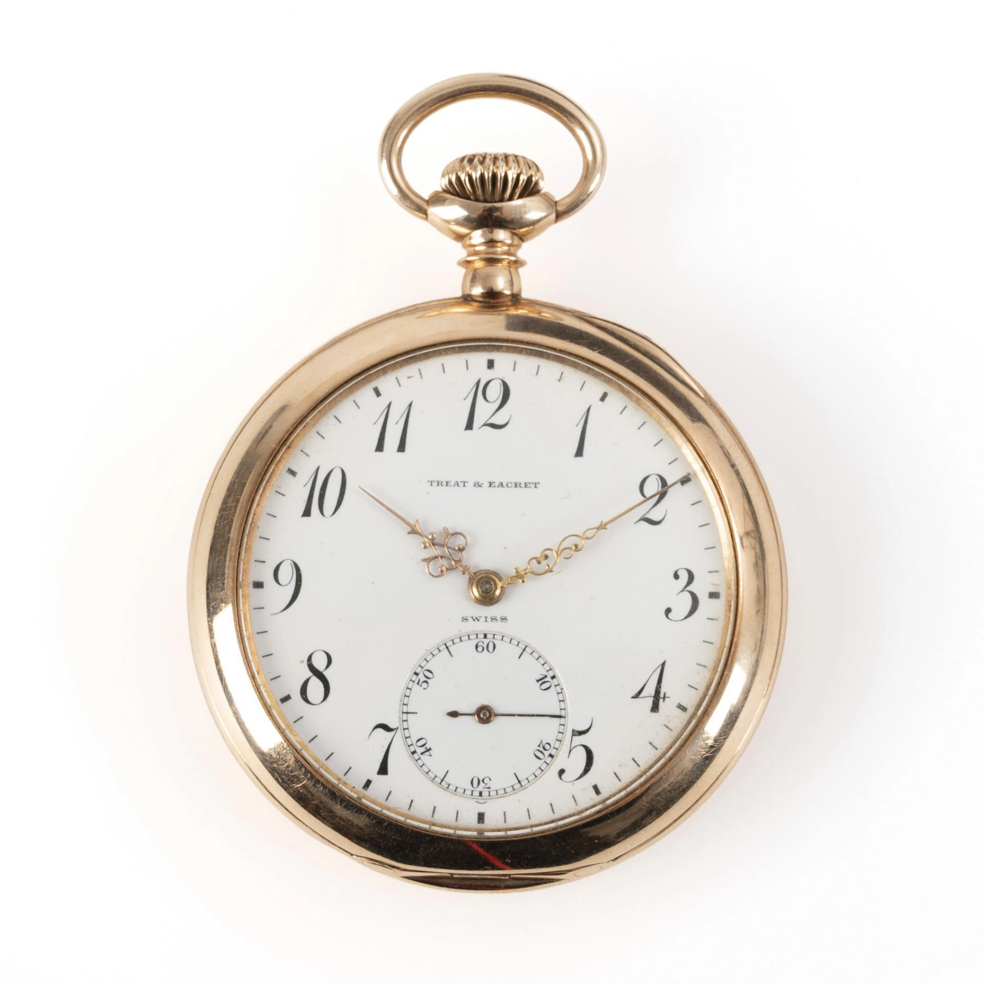 Gold pocket watch with monogram engraving.