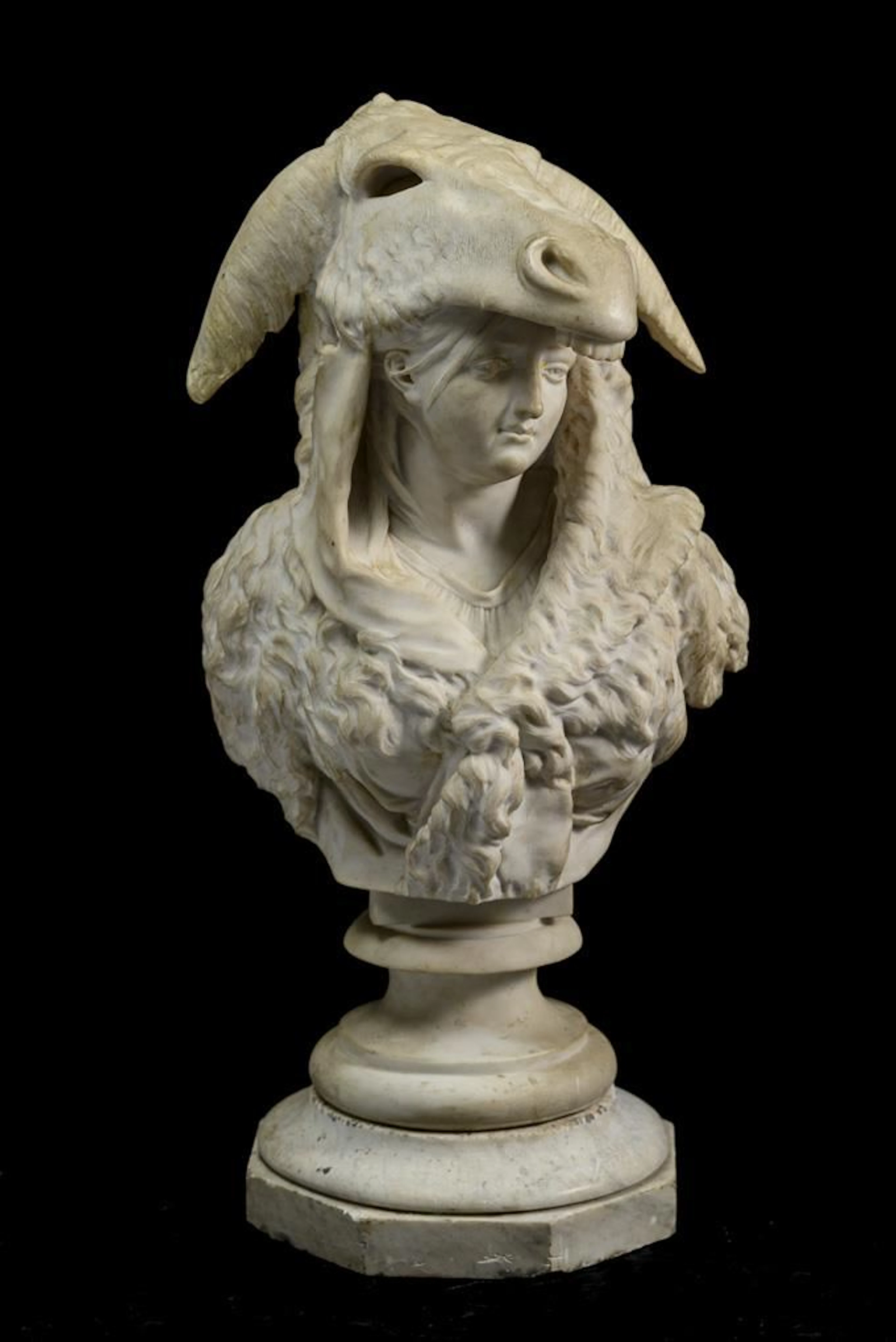 Large bust of a young woman wearing a donkey-skin cloak