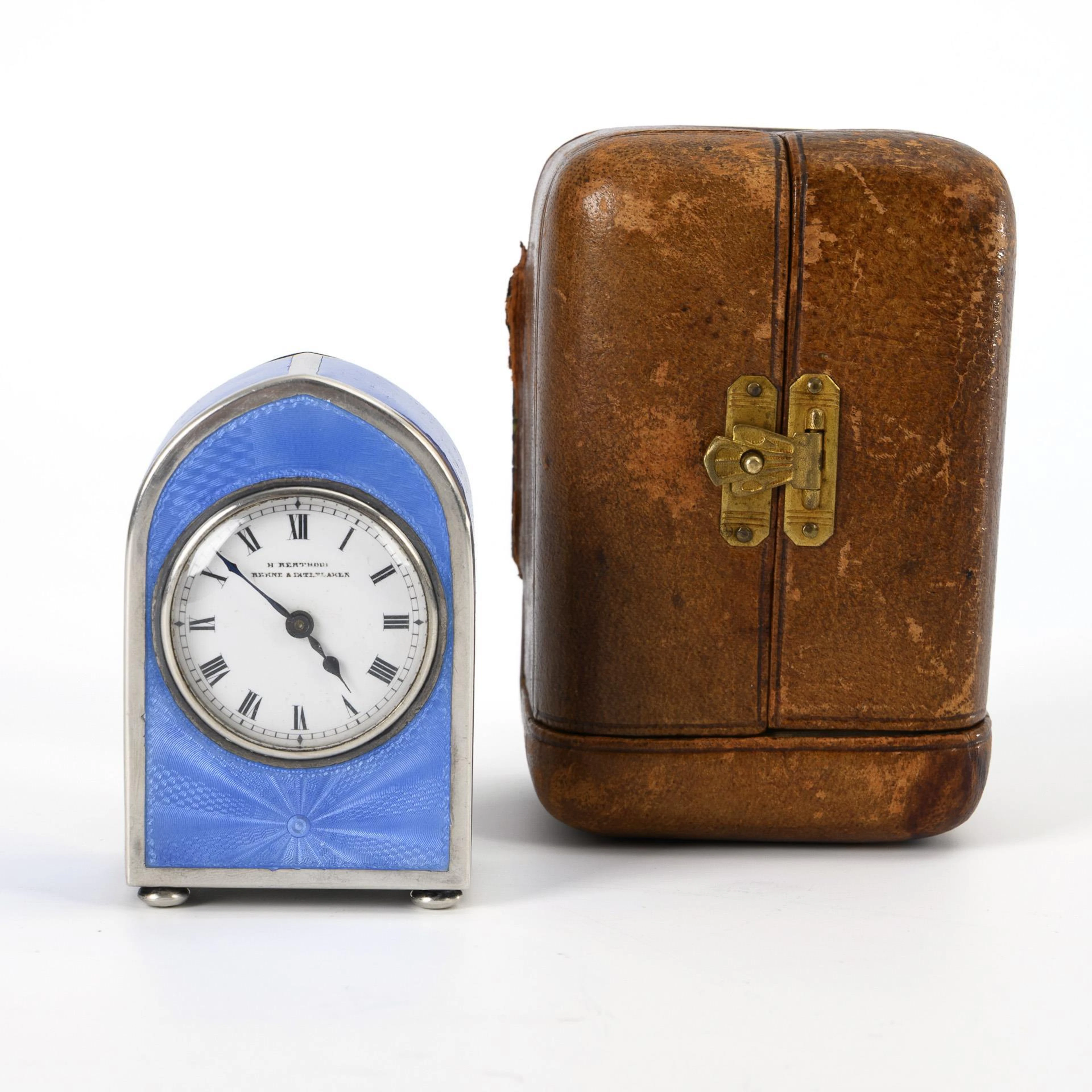 Small blue enameled table clock in travel casket.