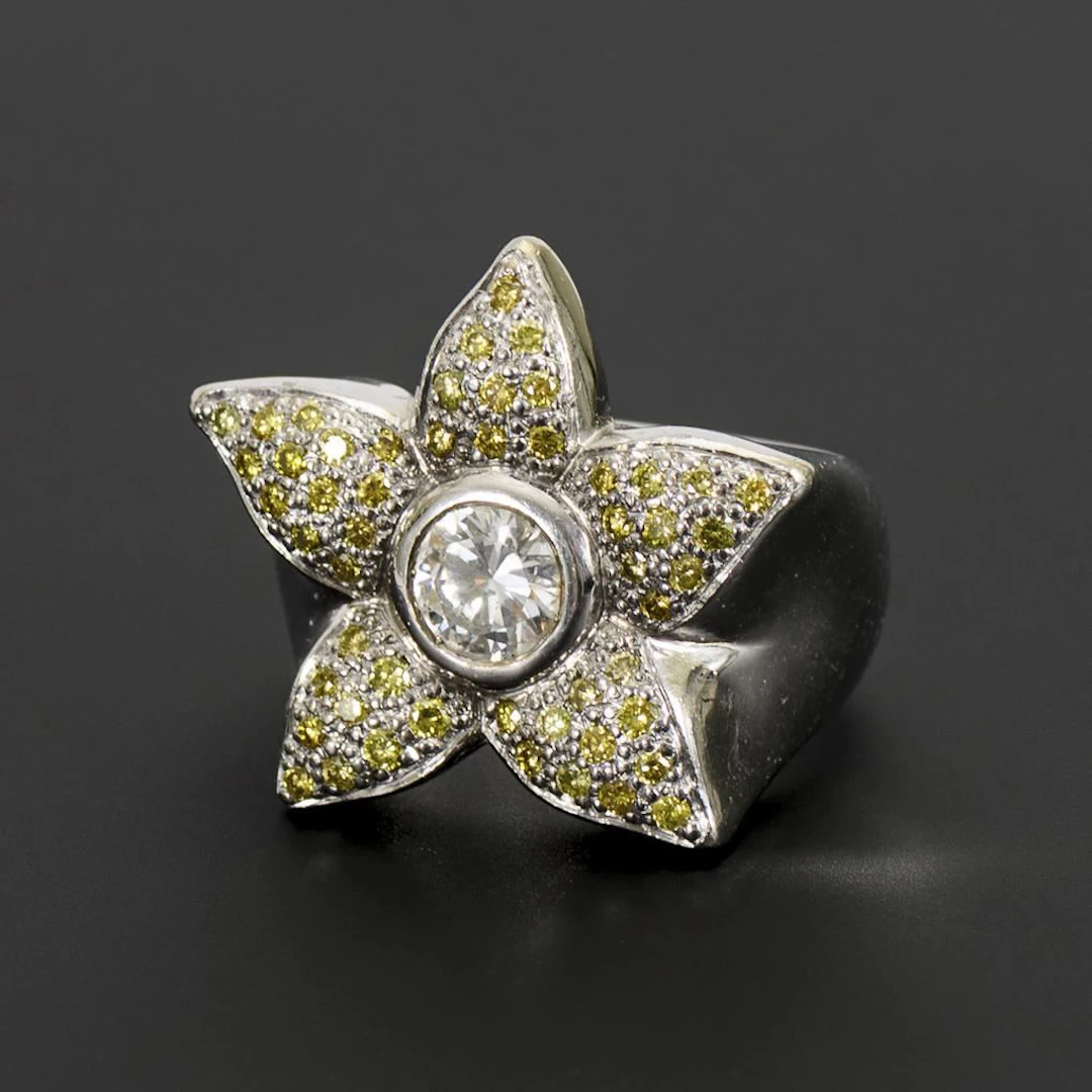 Flower-shaped ring with a lavish diamond setting.