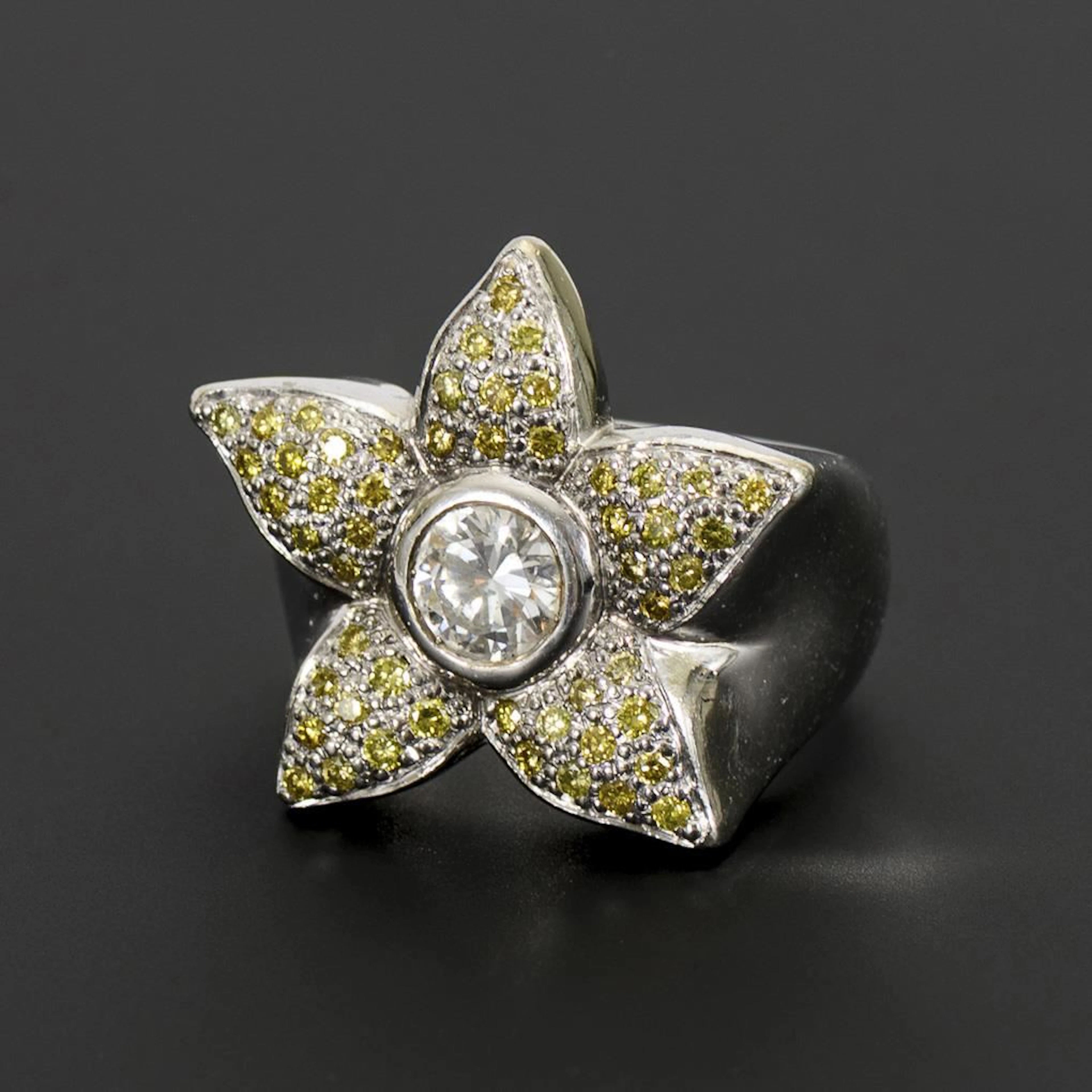 Flower-shaped ring with a lavish diamond setting.