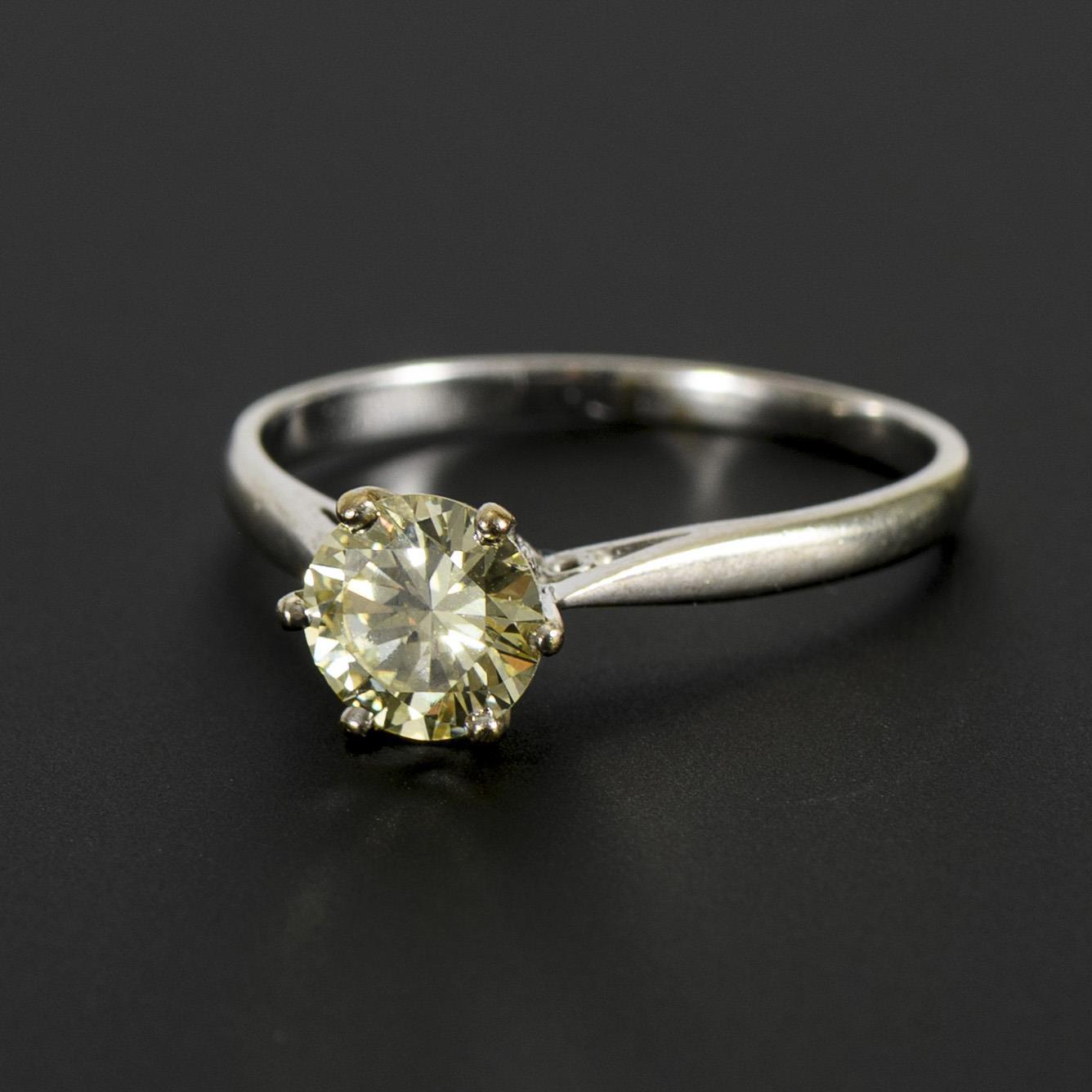 Ring with tinted diamond solitaire.