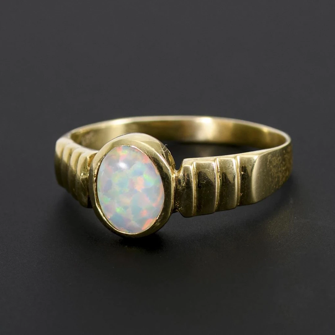 Ring with an opal doublet or triplet.