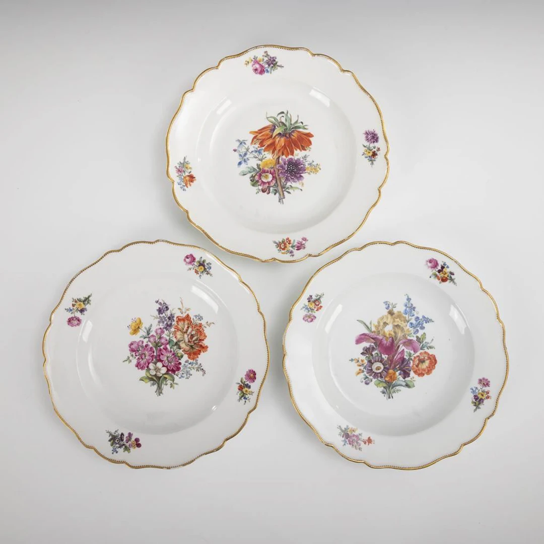 3 Baroque plates with floral designs. Meissen.