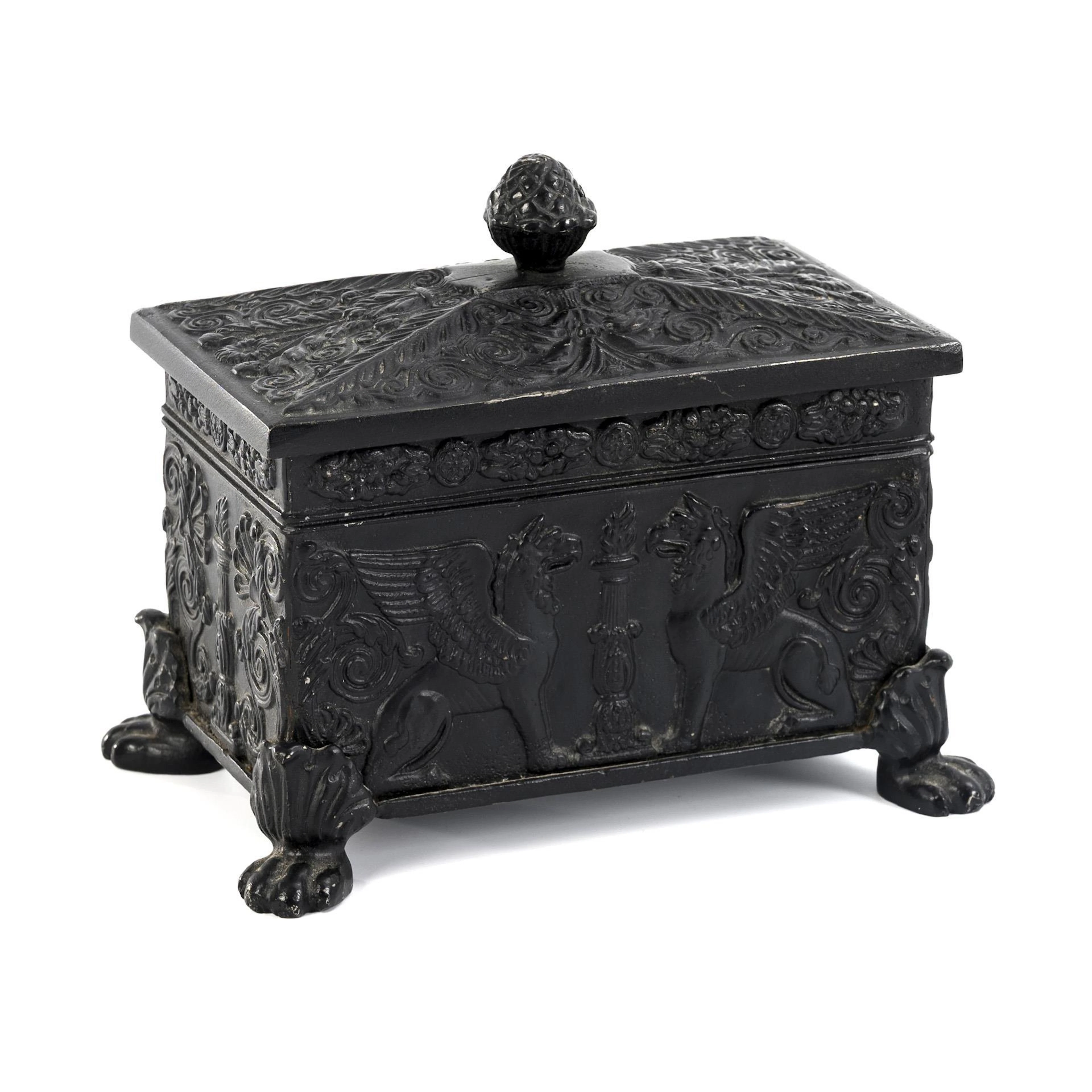 Cast iron tobacco box in Empire shape.