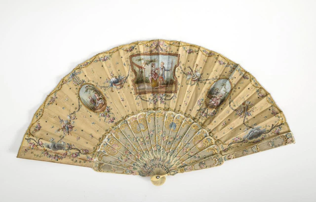 Historic Rococo fan featuring pastoral scenes.
