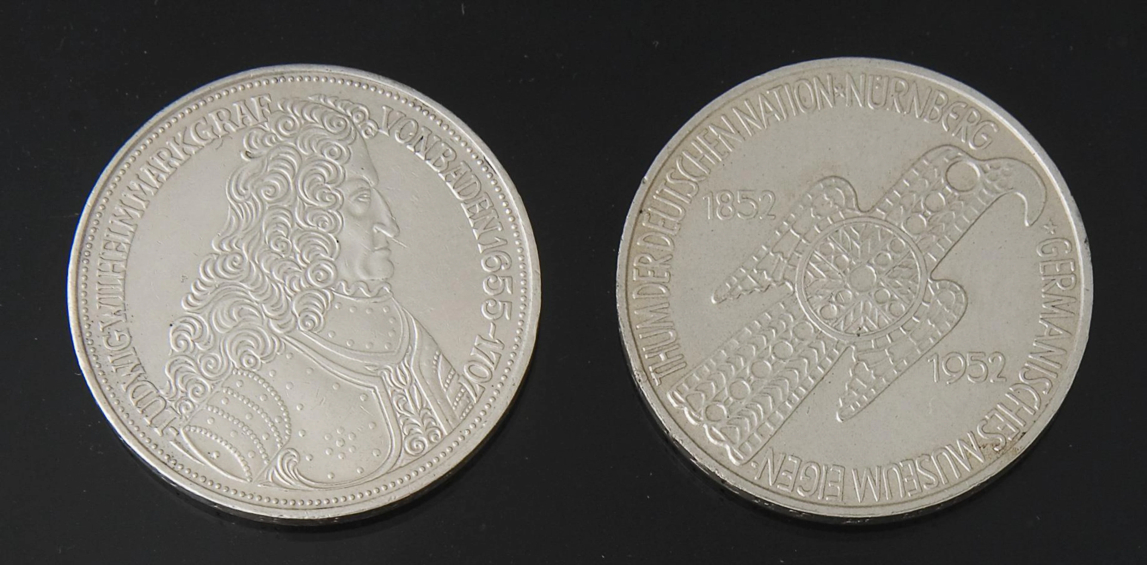 2 silver commemorative coins.