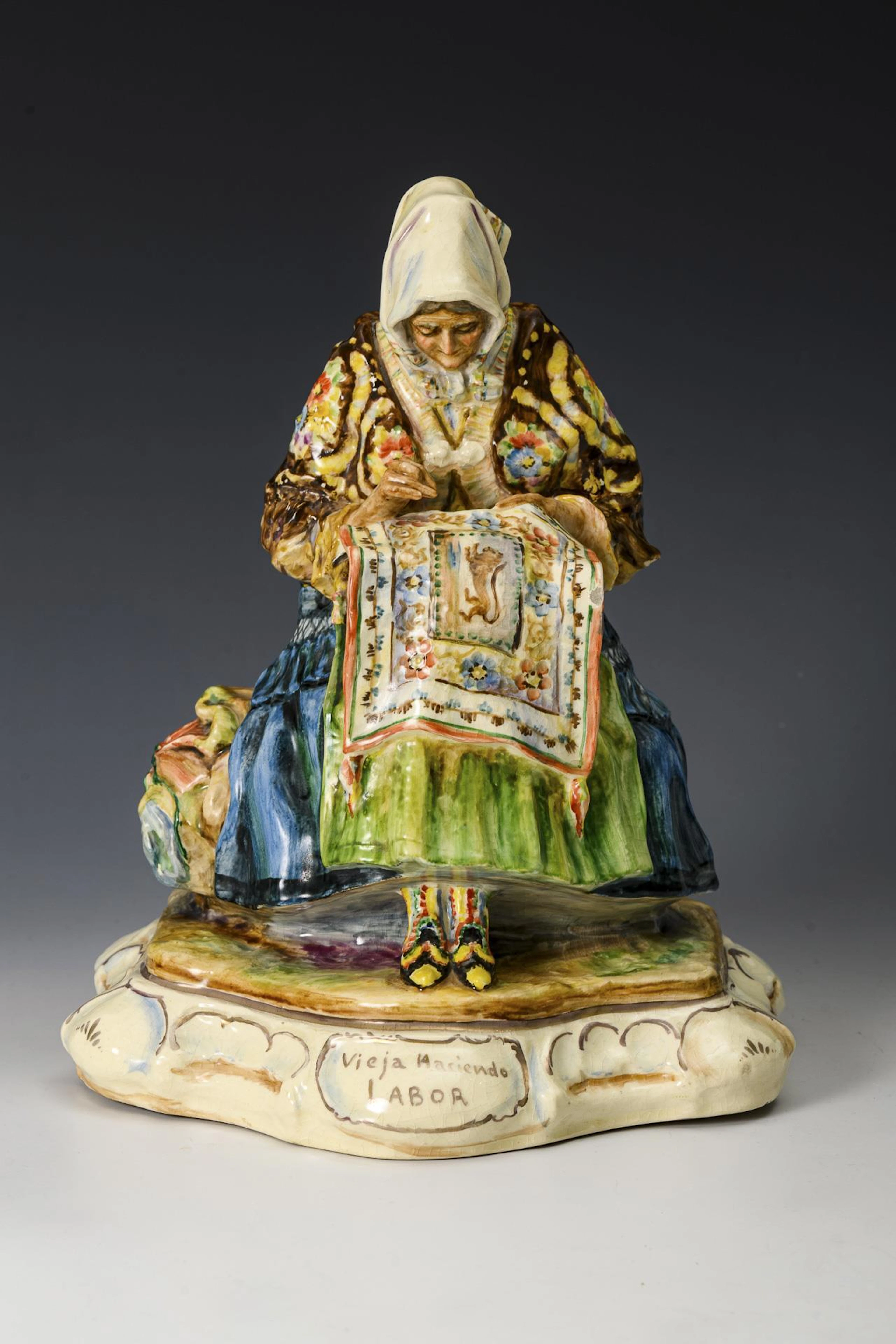 Majolica genre figure "Vieja Haciendo Labor" (An old woman doing housework).