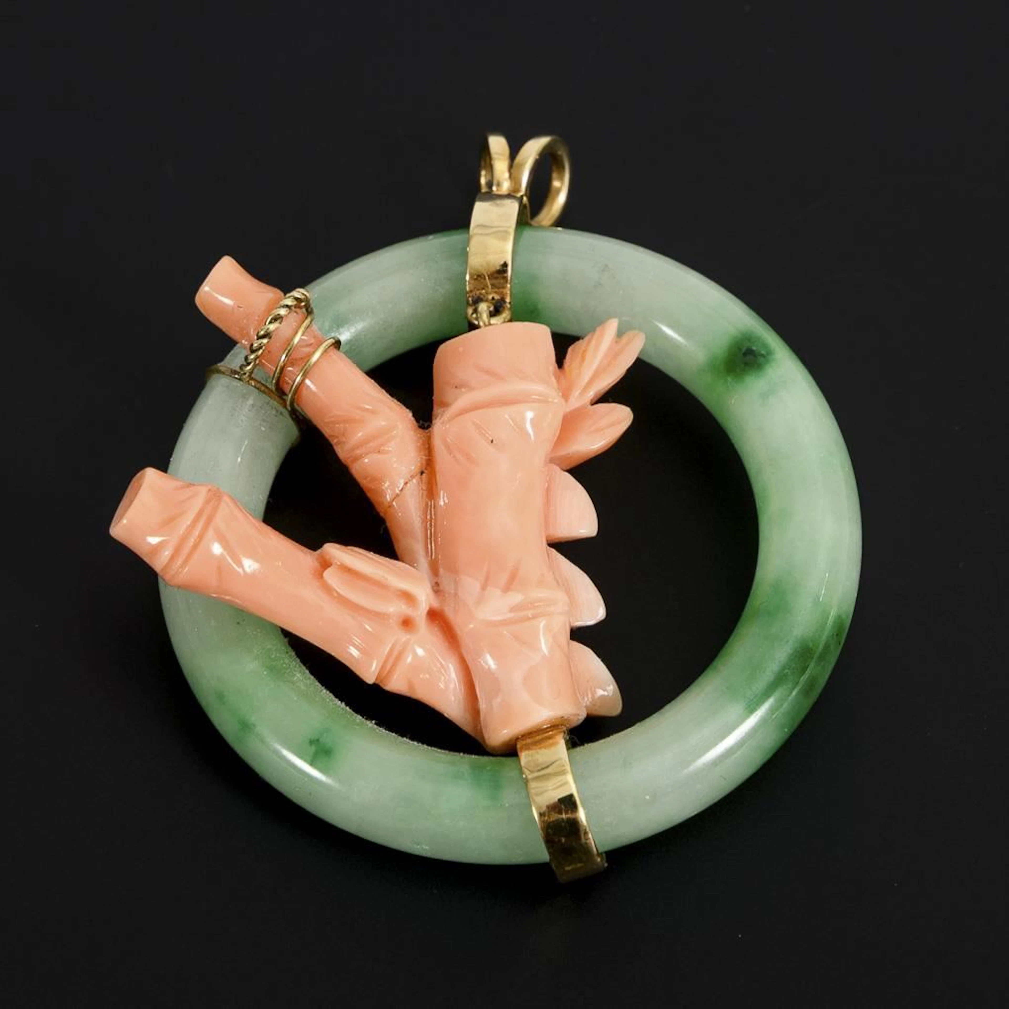 Pendant with coral and jade ring.