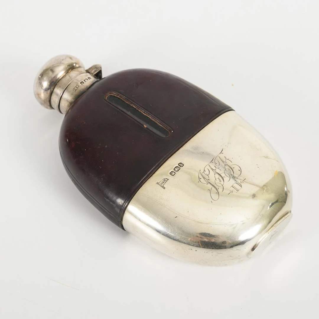 English liquor bottle with removable silver cup.