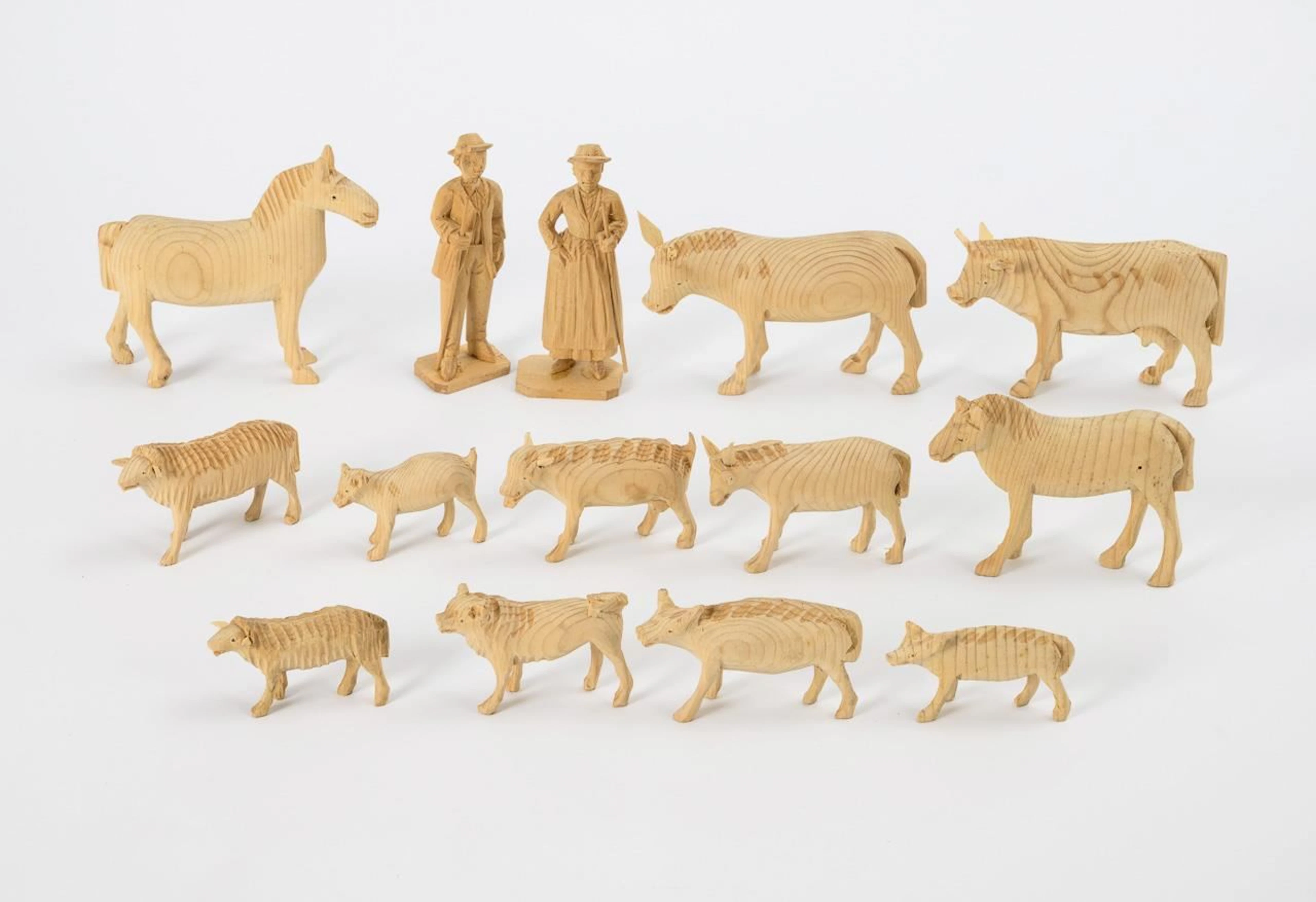 12 carved wooden animals and 2 shepherds, in a red box. Val Gardena.