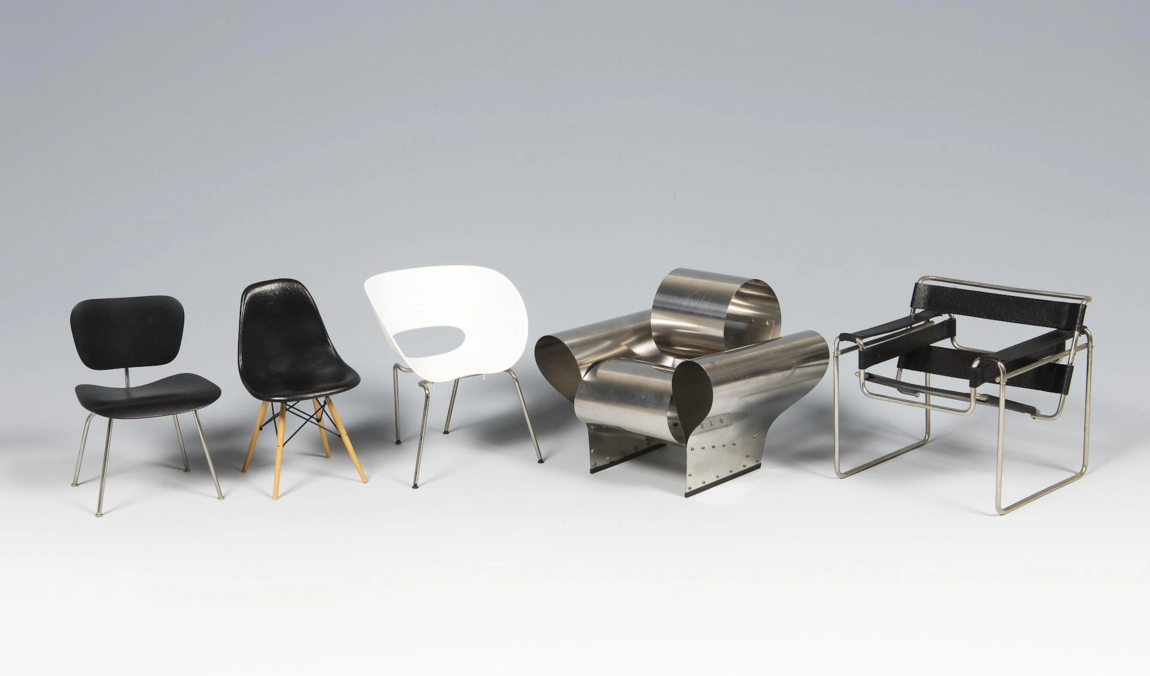 5 miniature design armchairs.
