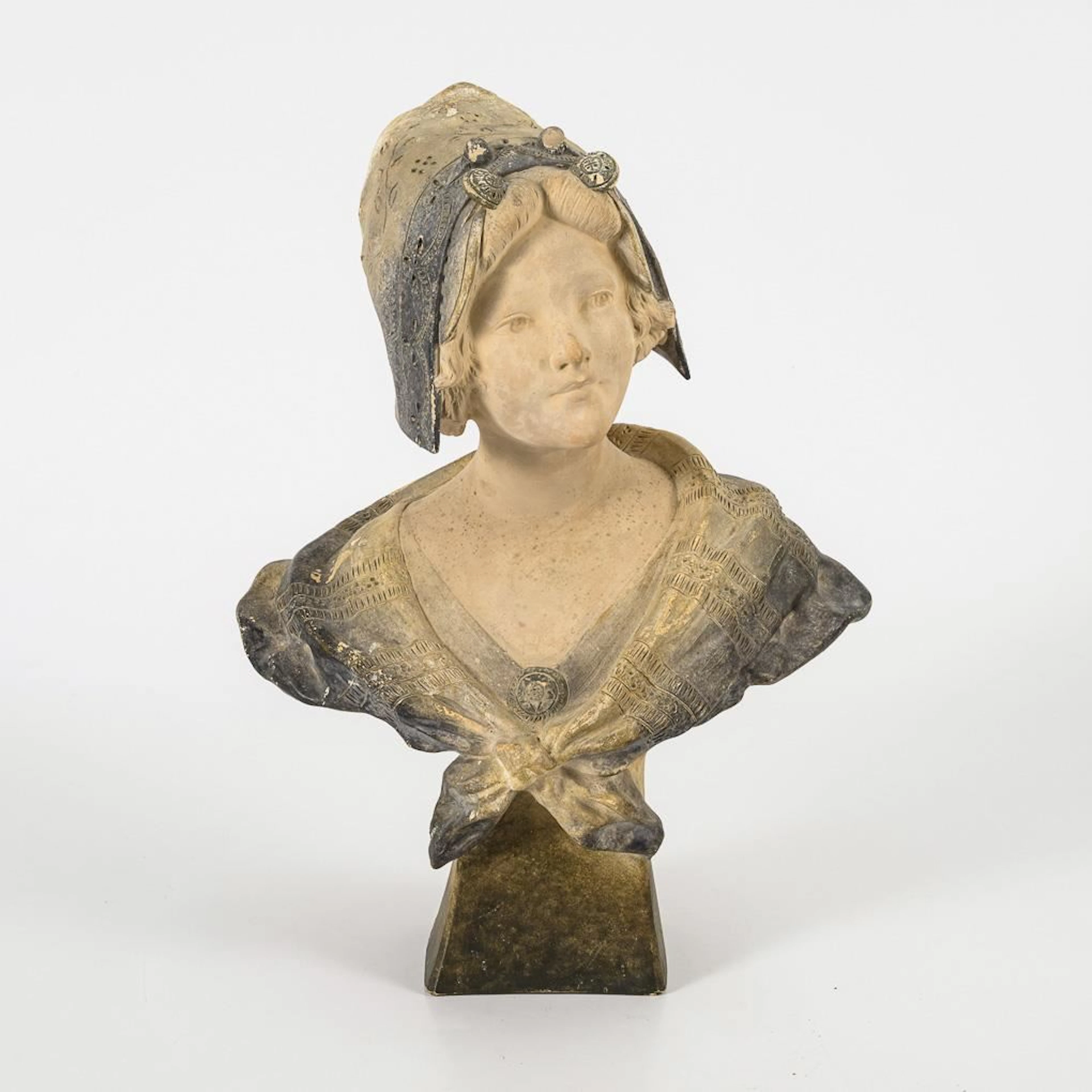 Bust of a girl wearing a bonnet.
