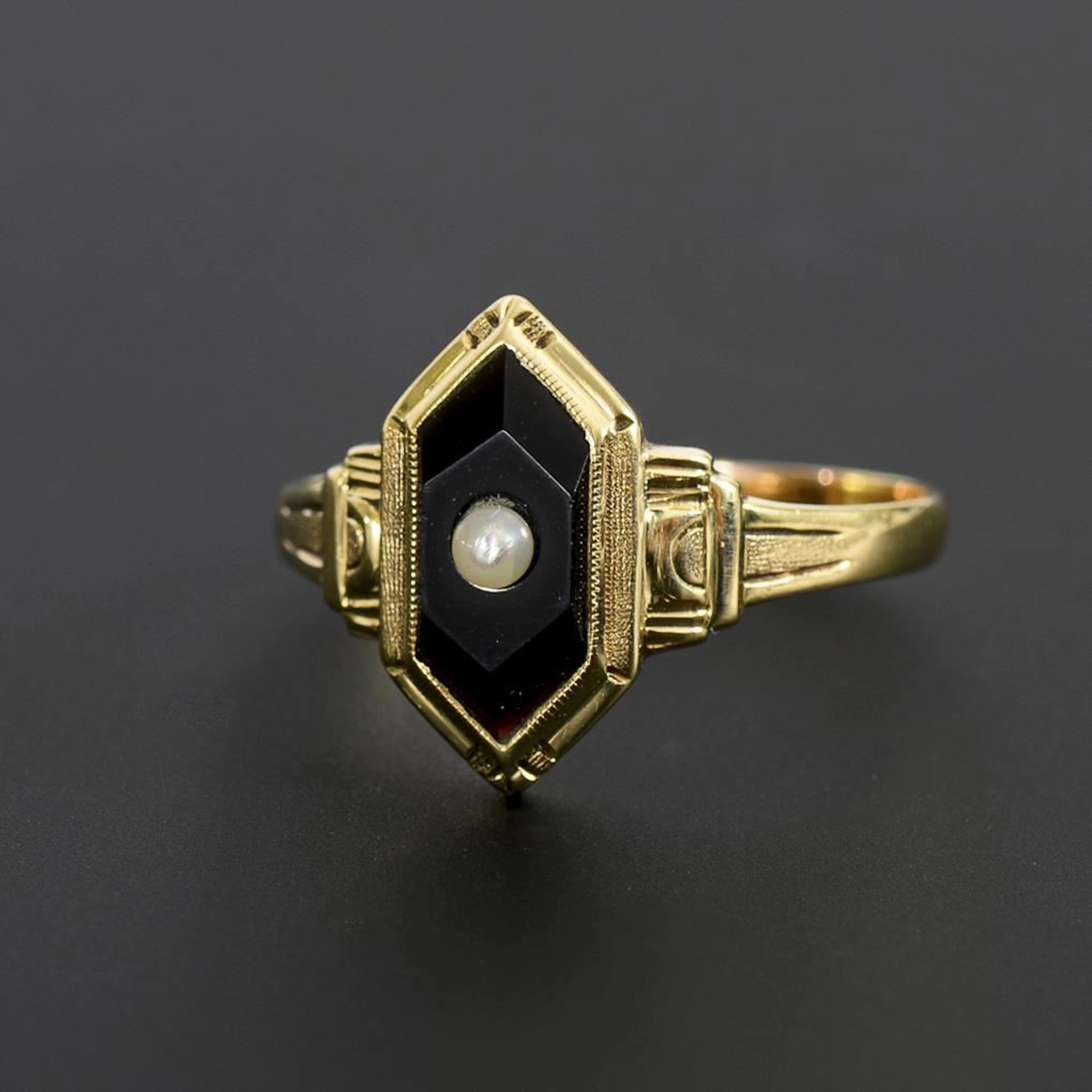 Vintage ring with an onyx setting and a small pearl.