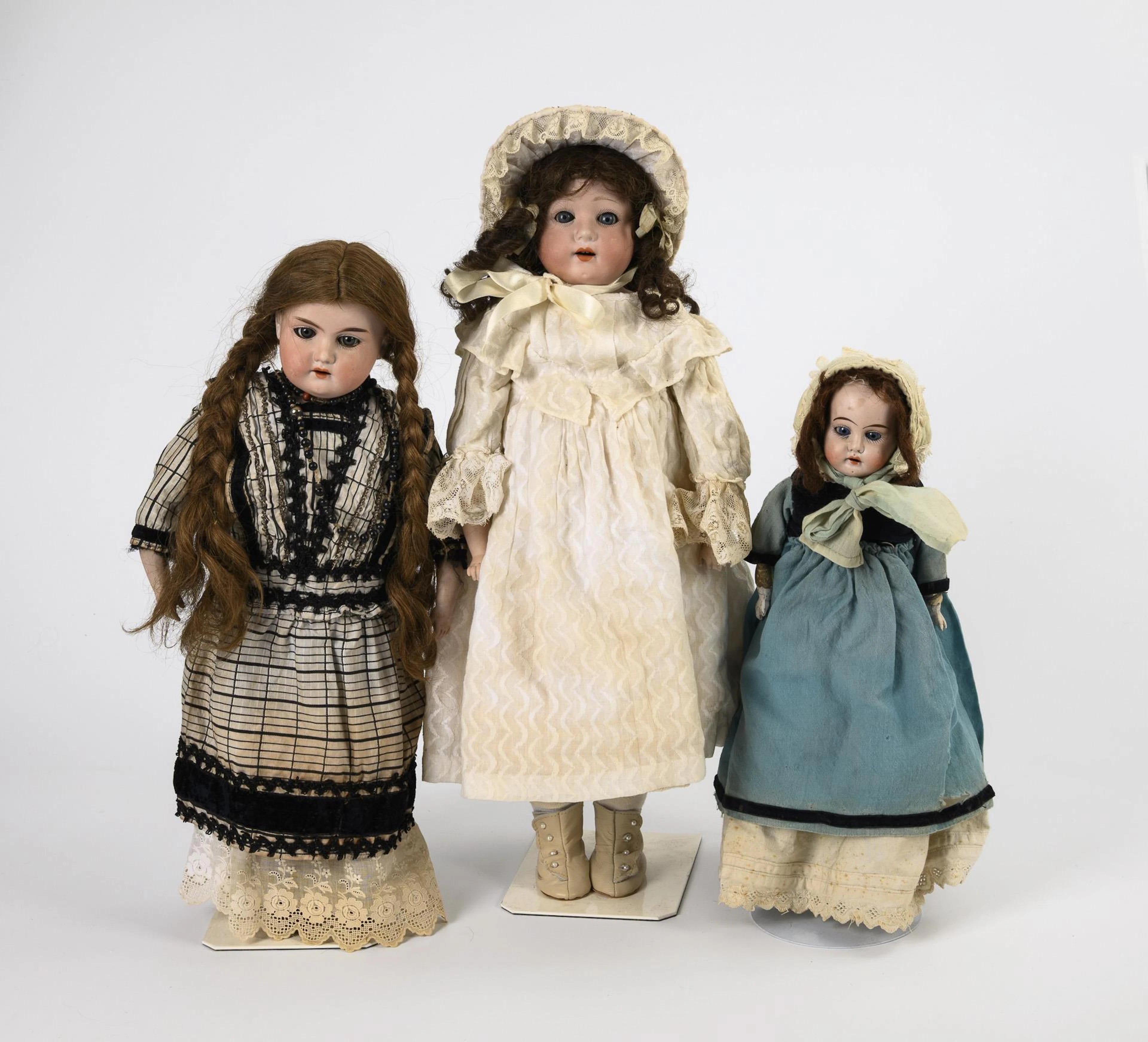 3 chest head dolls.