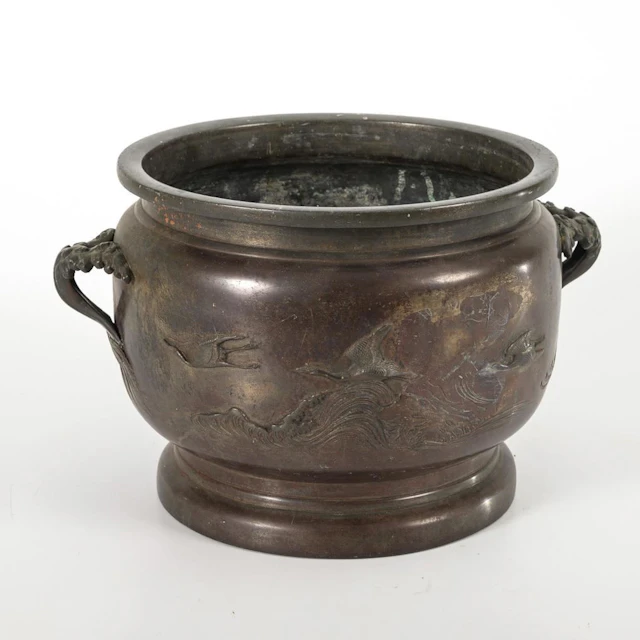 A bronze vessel with beautiful relief work.