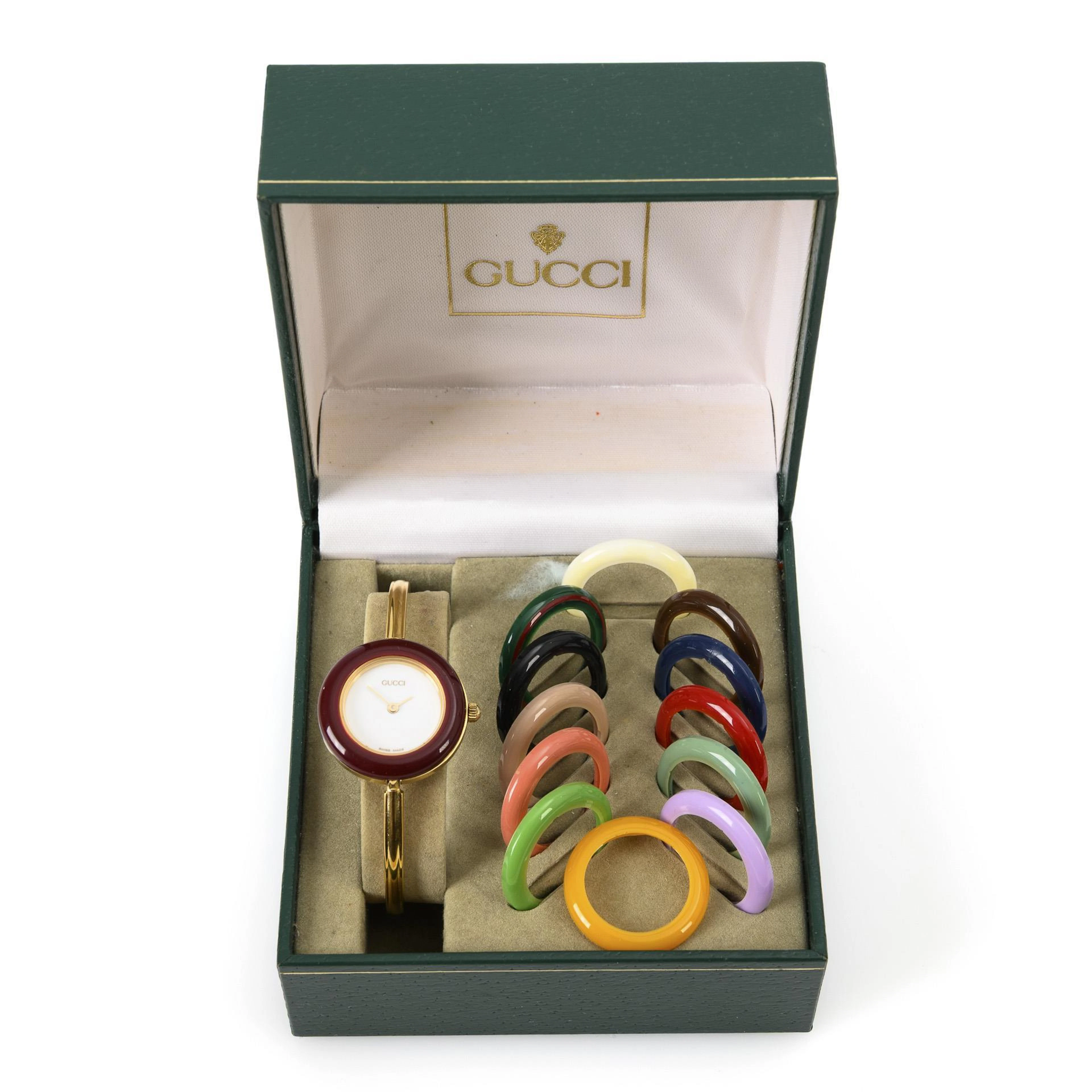 Delicate ladies' wristwatch with interchangeable color bezels. Guccci.