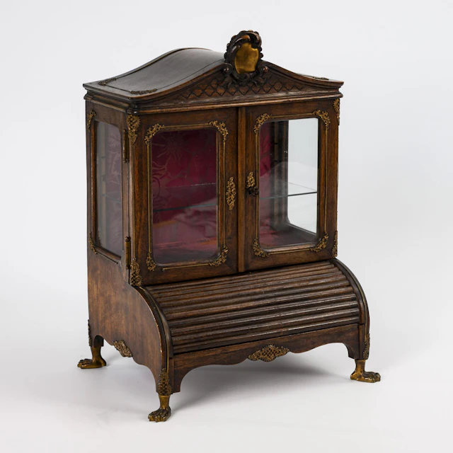 Miniature baroque-style roll-top secretary with pocket watch holder.