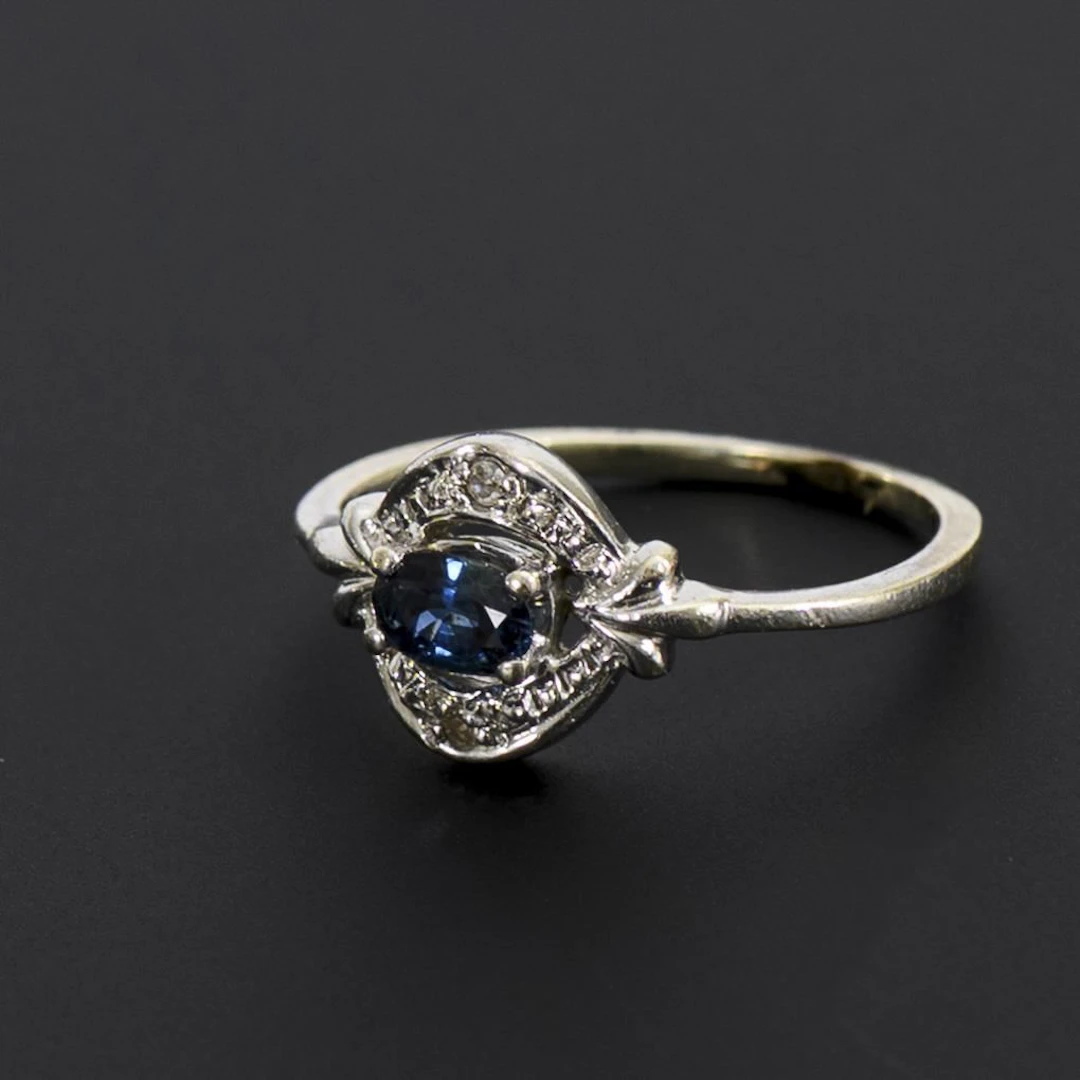 Art Deco ring with a blue gemstone, likely a sapphire.