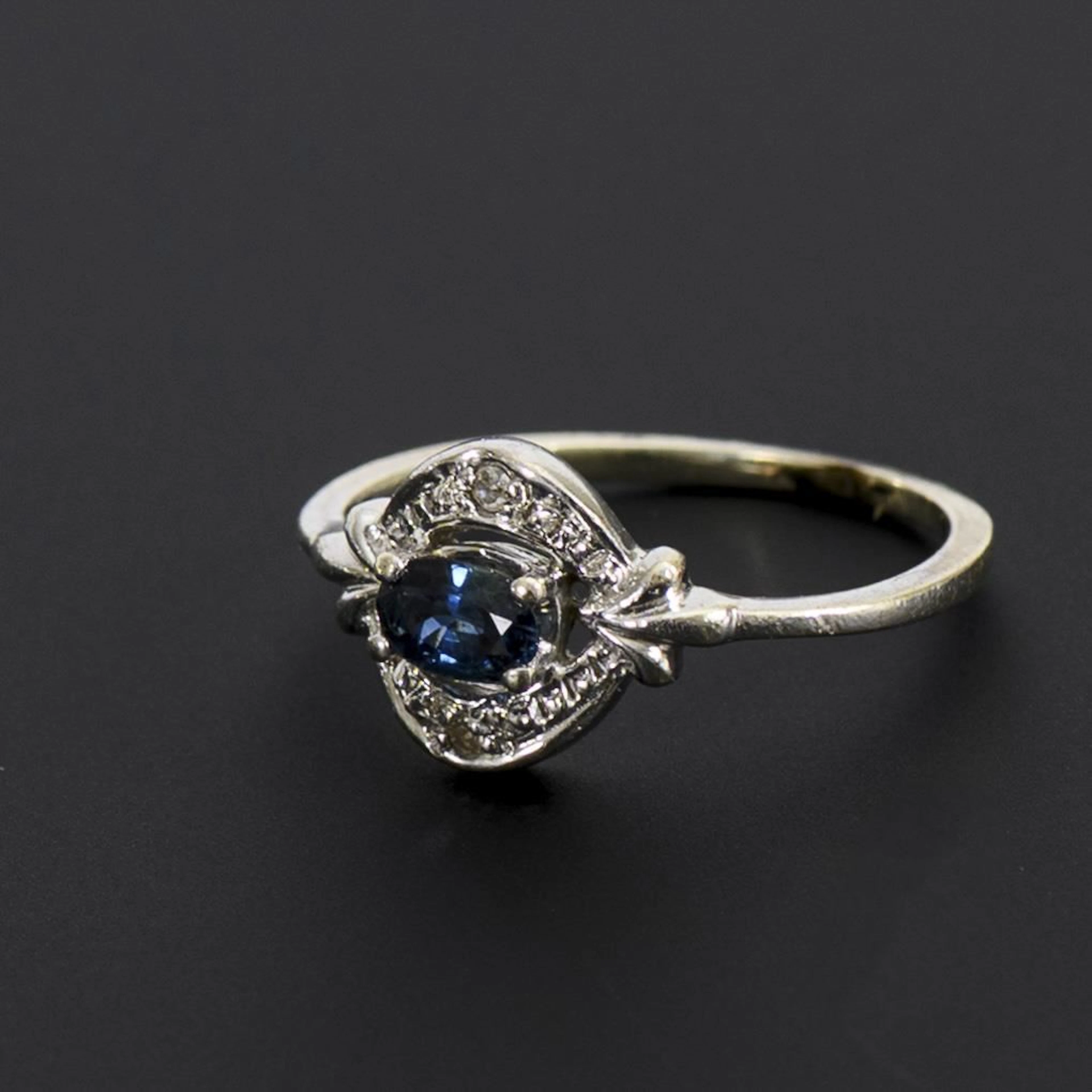 Art Deco ring with a blue gemstone, likely a sapphire.