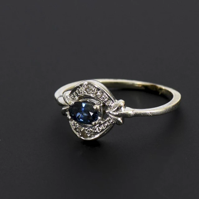 Art Deco ring with a blue gemstone, likely a sapphire.