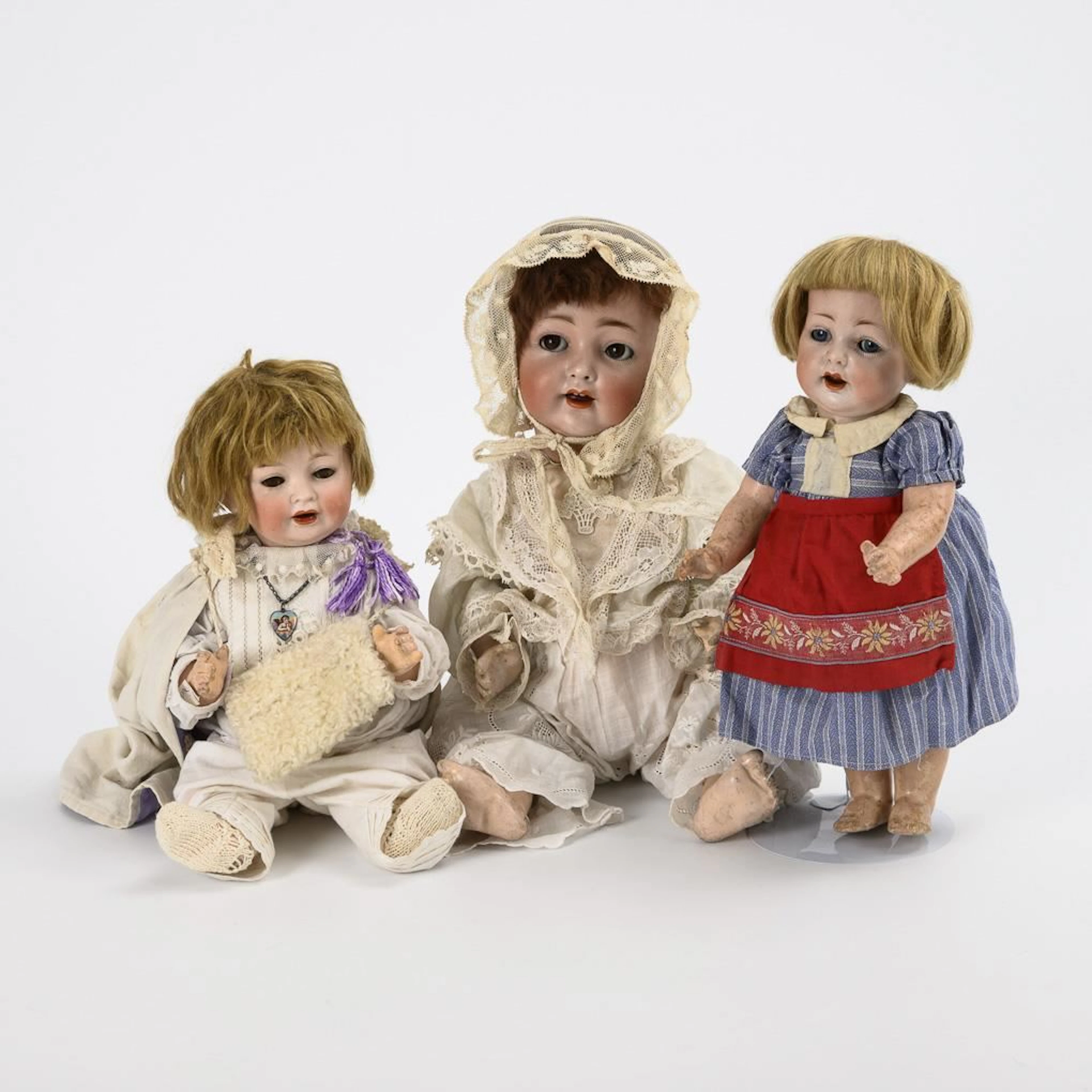 3 character dolls with porcelain heads.