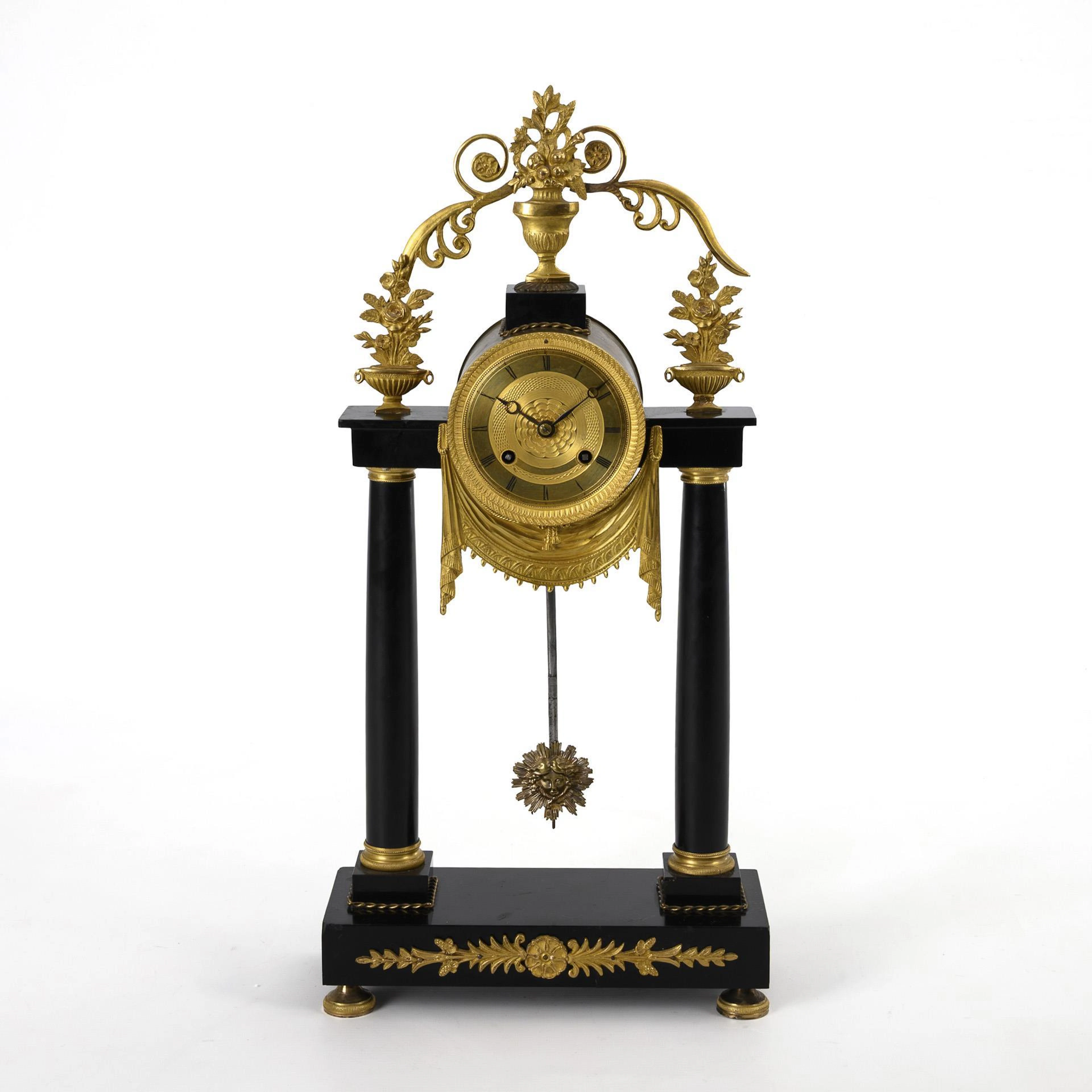Late-tempire portal clock with vase finial.