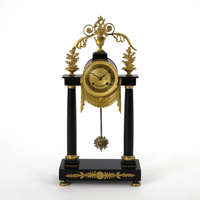 Late-tempire portal clock with vase finial.