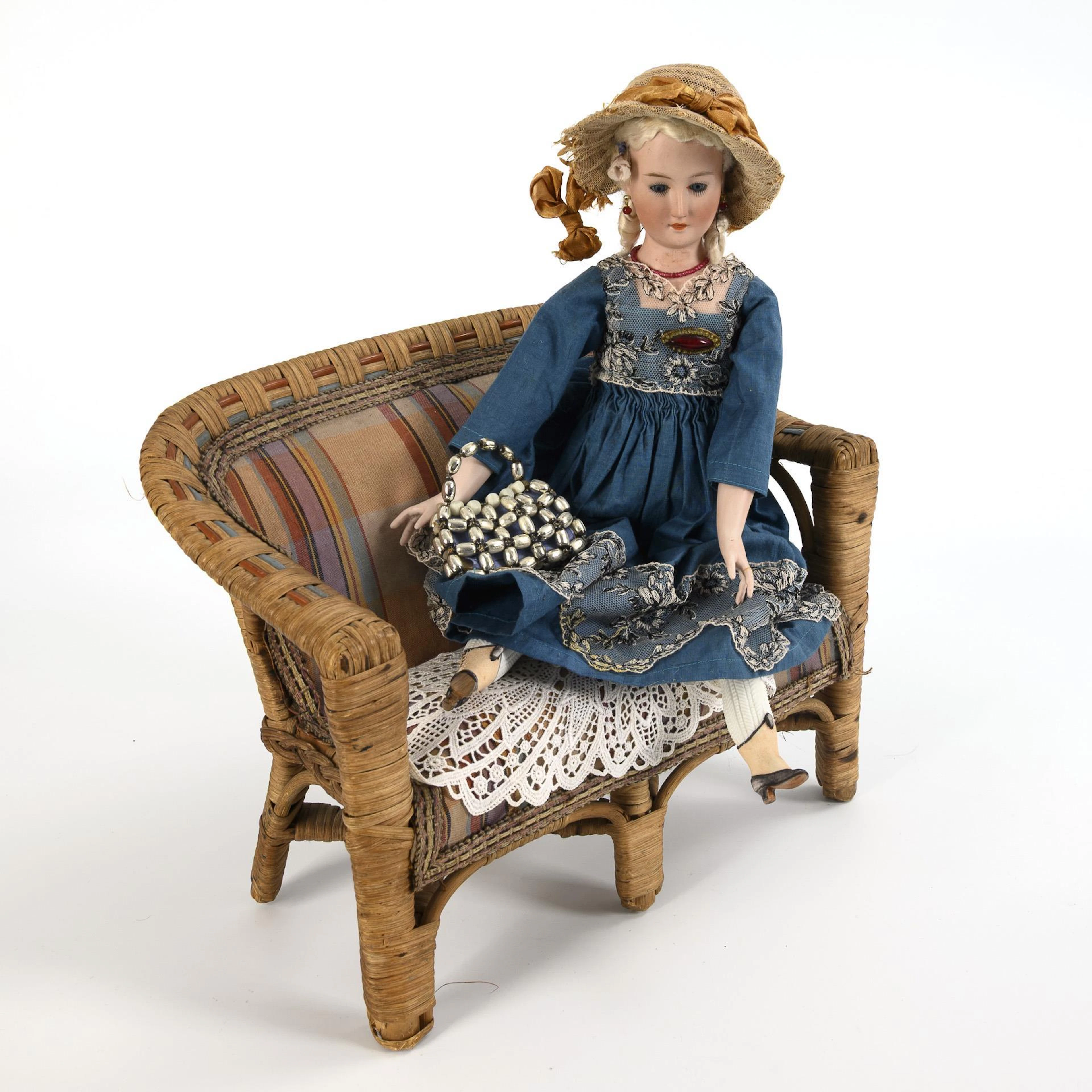 Elegant doll lady in the style of a tea doll, with sofa.