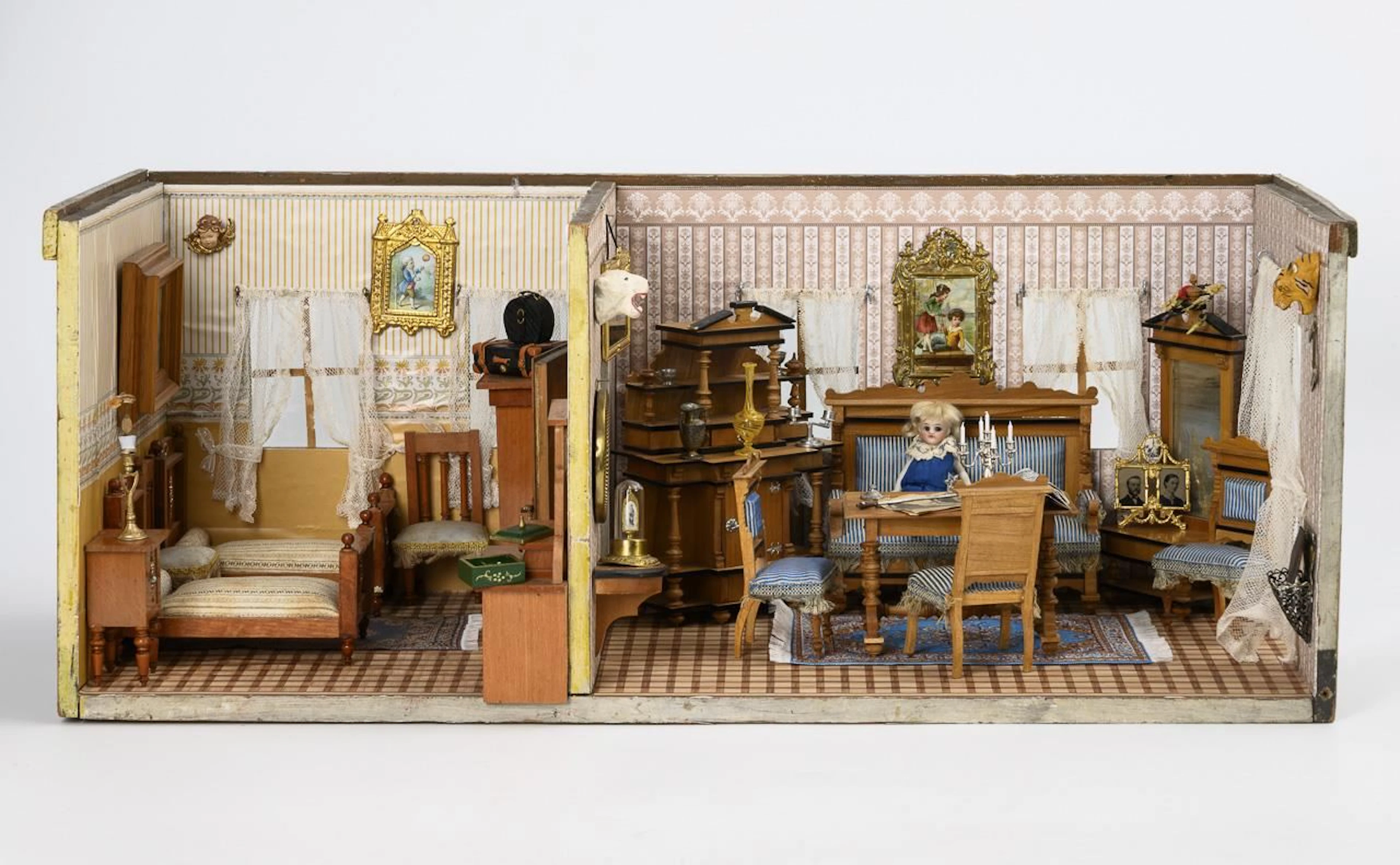 Decoratively furnished two-room dollhouse.