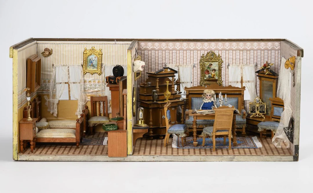 Decoratively furnished two-room dollhouse.
