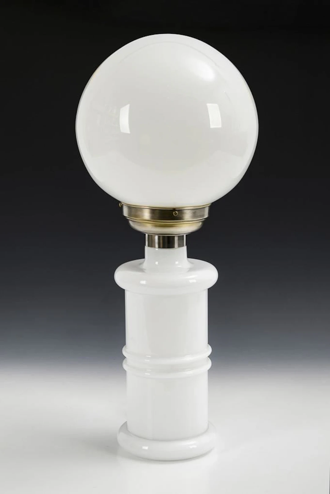 White Art Deco table lamp with a spherical shade.