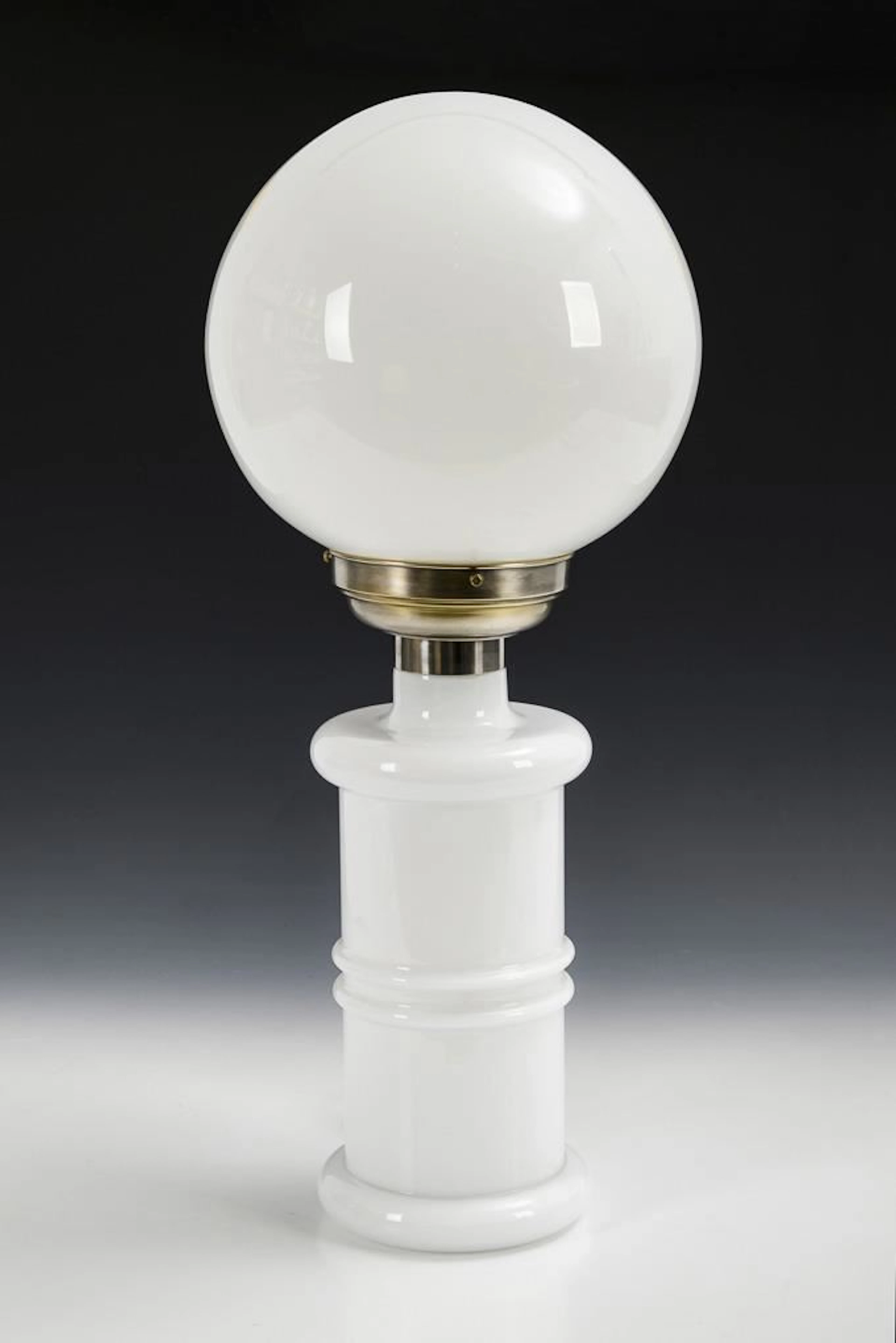 White Art Deco table lamp with a spherical shade.
