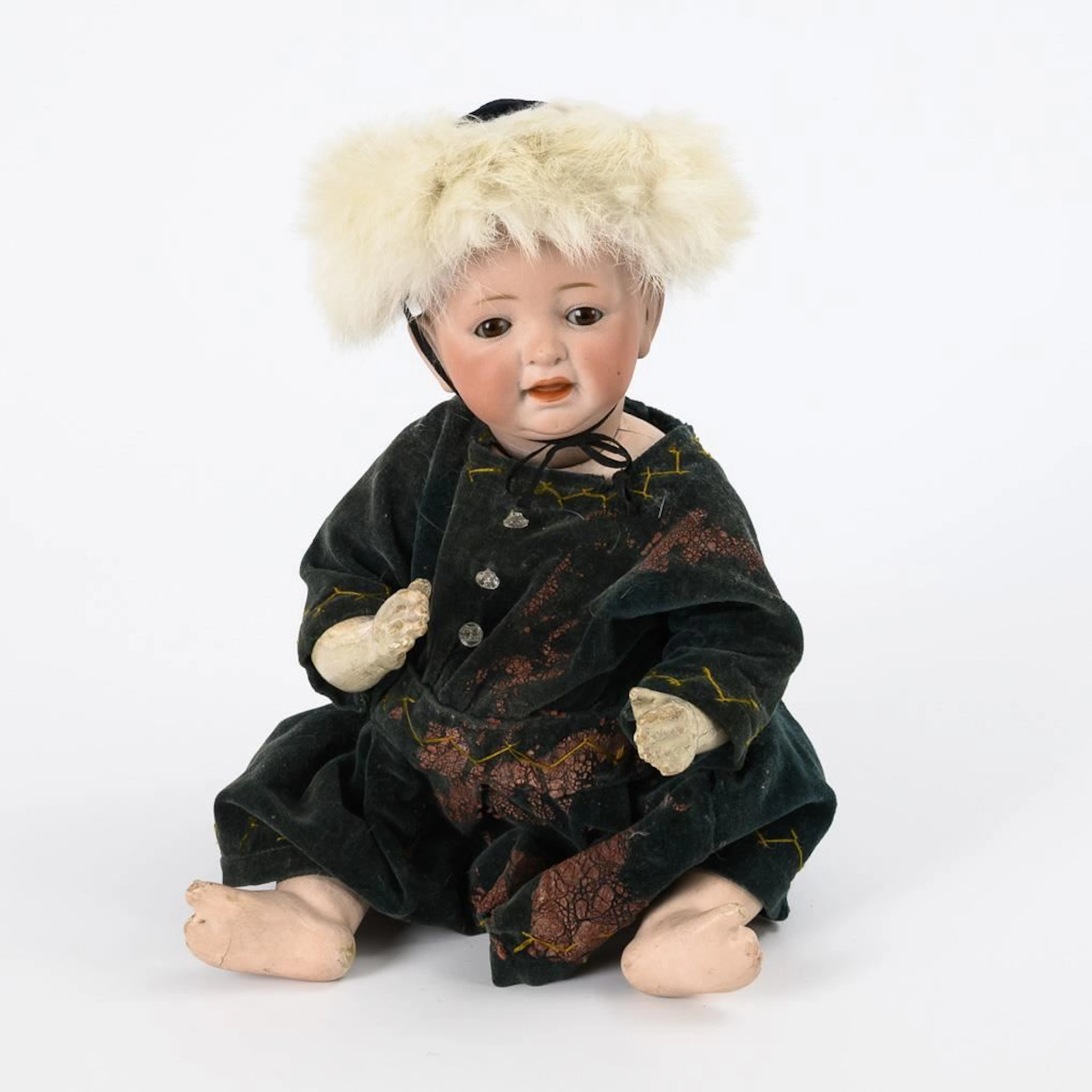 Small figurine of a boy wearing a fur hat. J.D. Kestner.