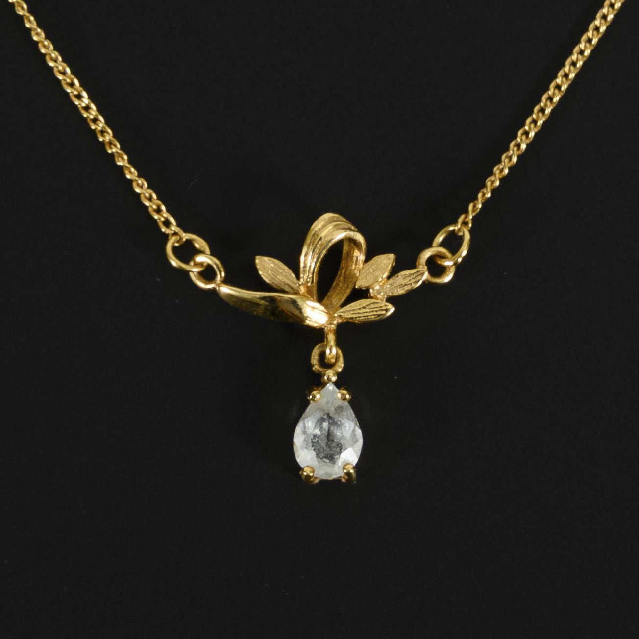 Delicate necklace with blue colored stone, probably blue topaz.