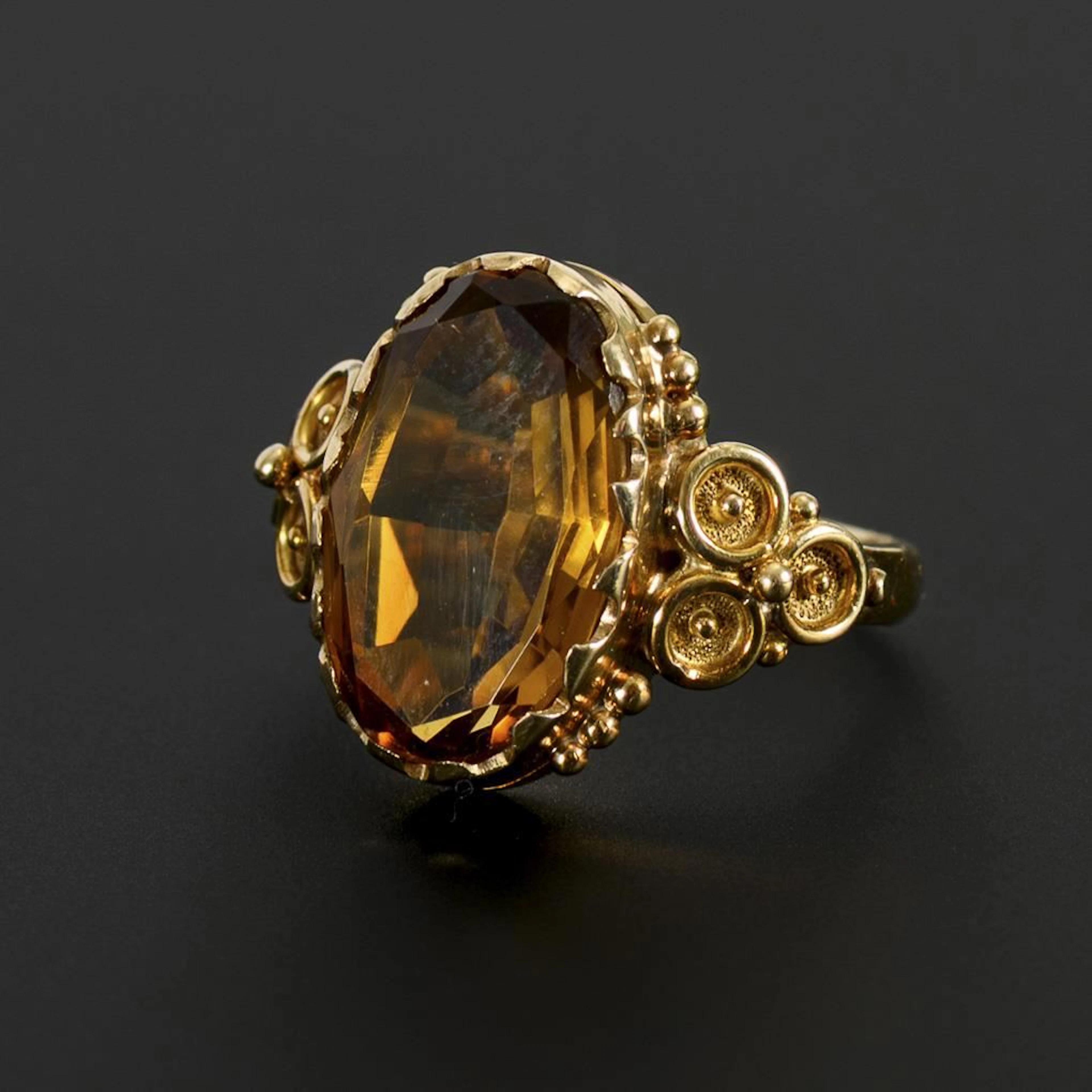 Ring with a cognac-colored gemstone, likely citrine.