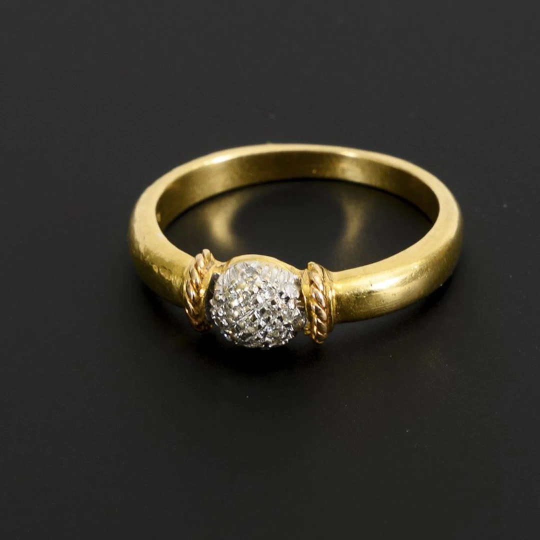 Two-tone ring with a spherical band and small brilliant-cut diamonds.