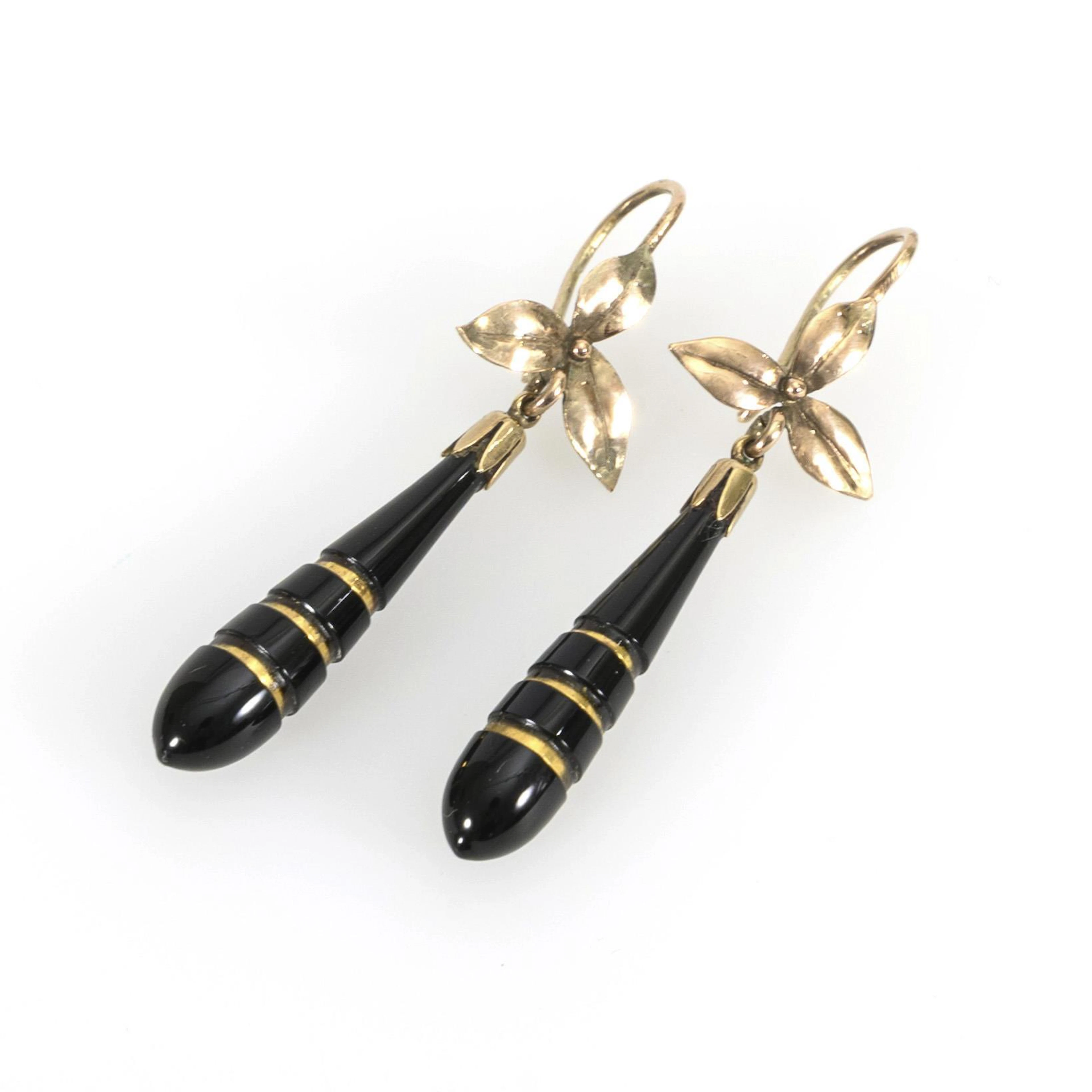 Floral earrings with black pompoms.