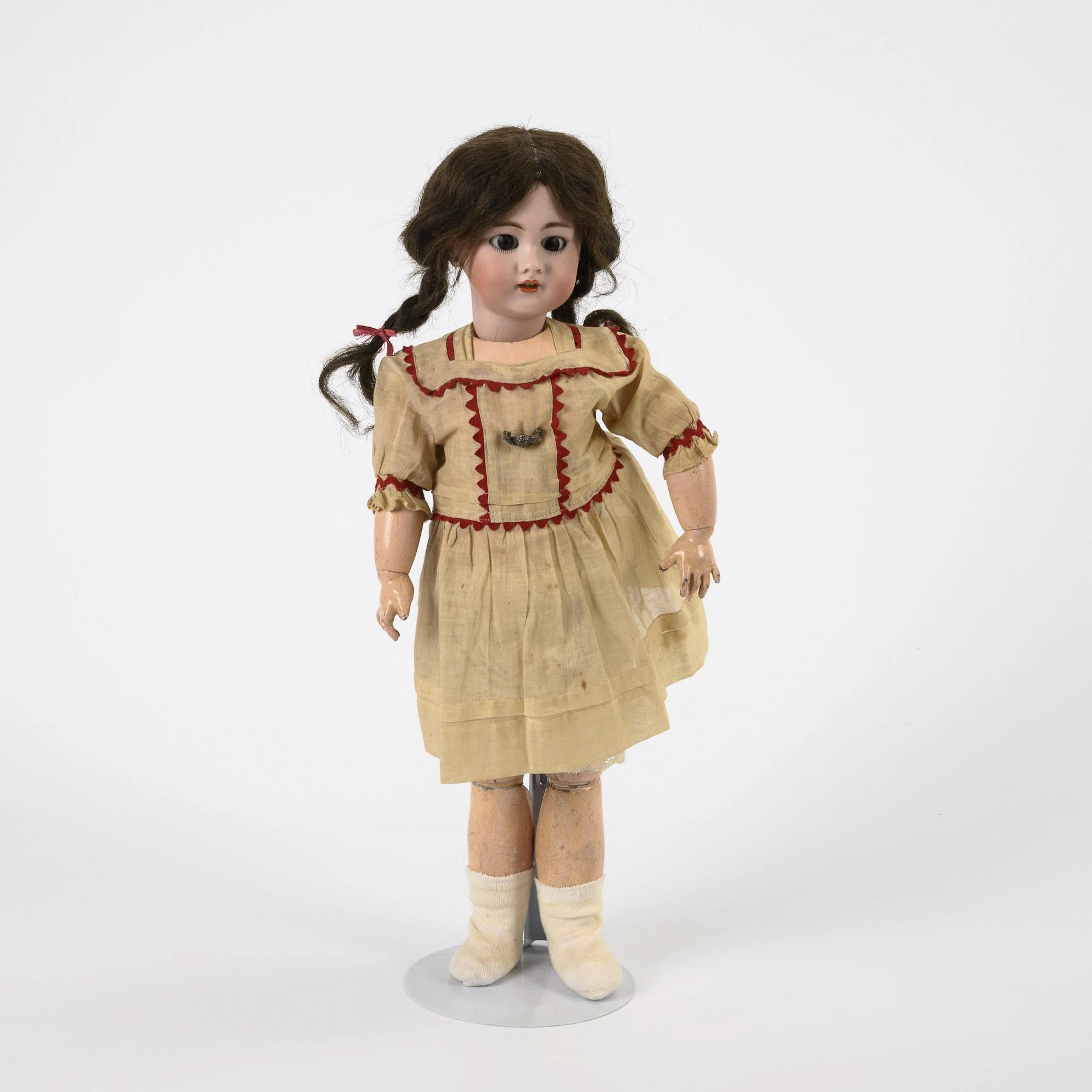Doll girl with brown pigtails.