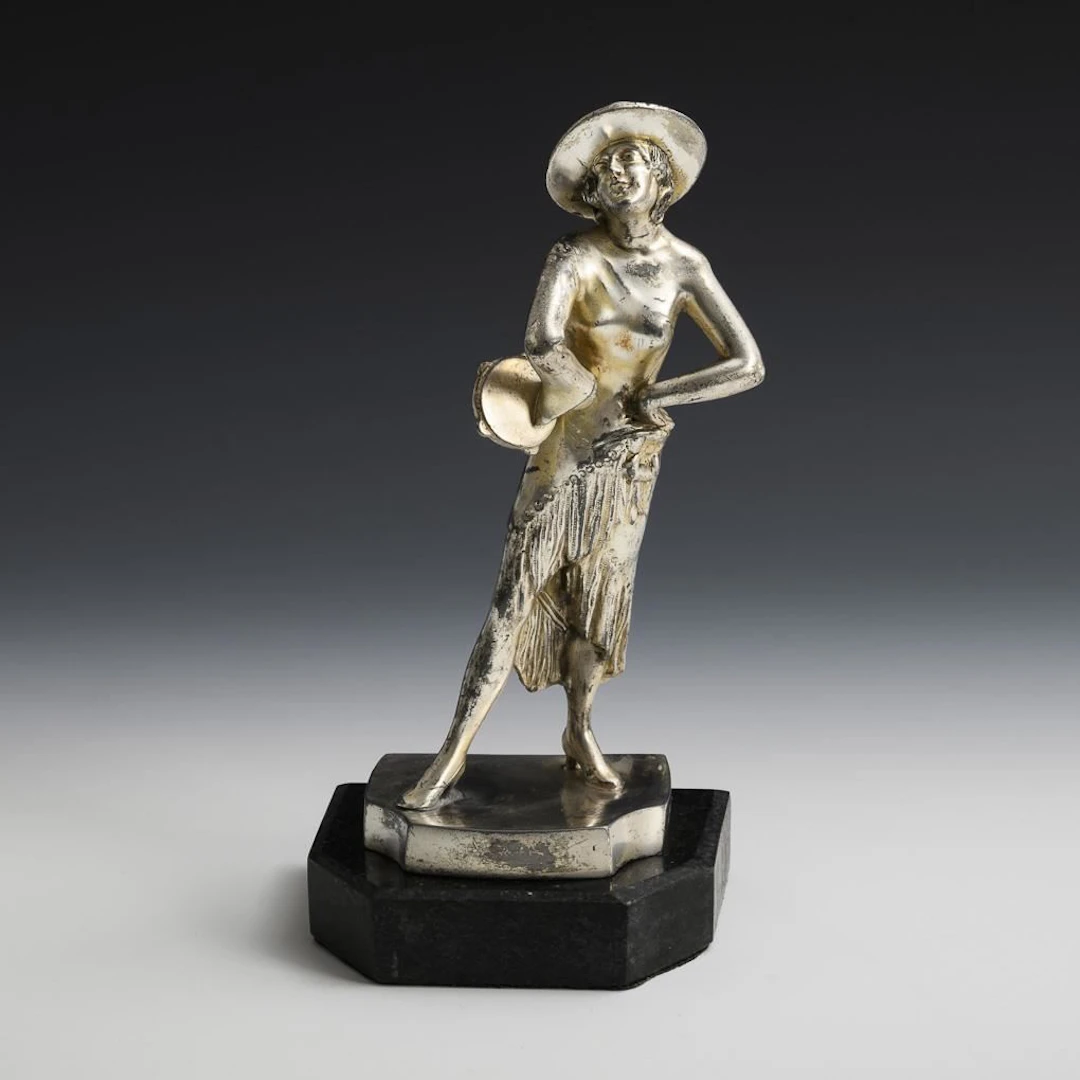 Female figure with tambourine. WMF.