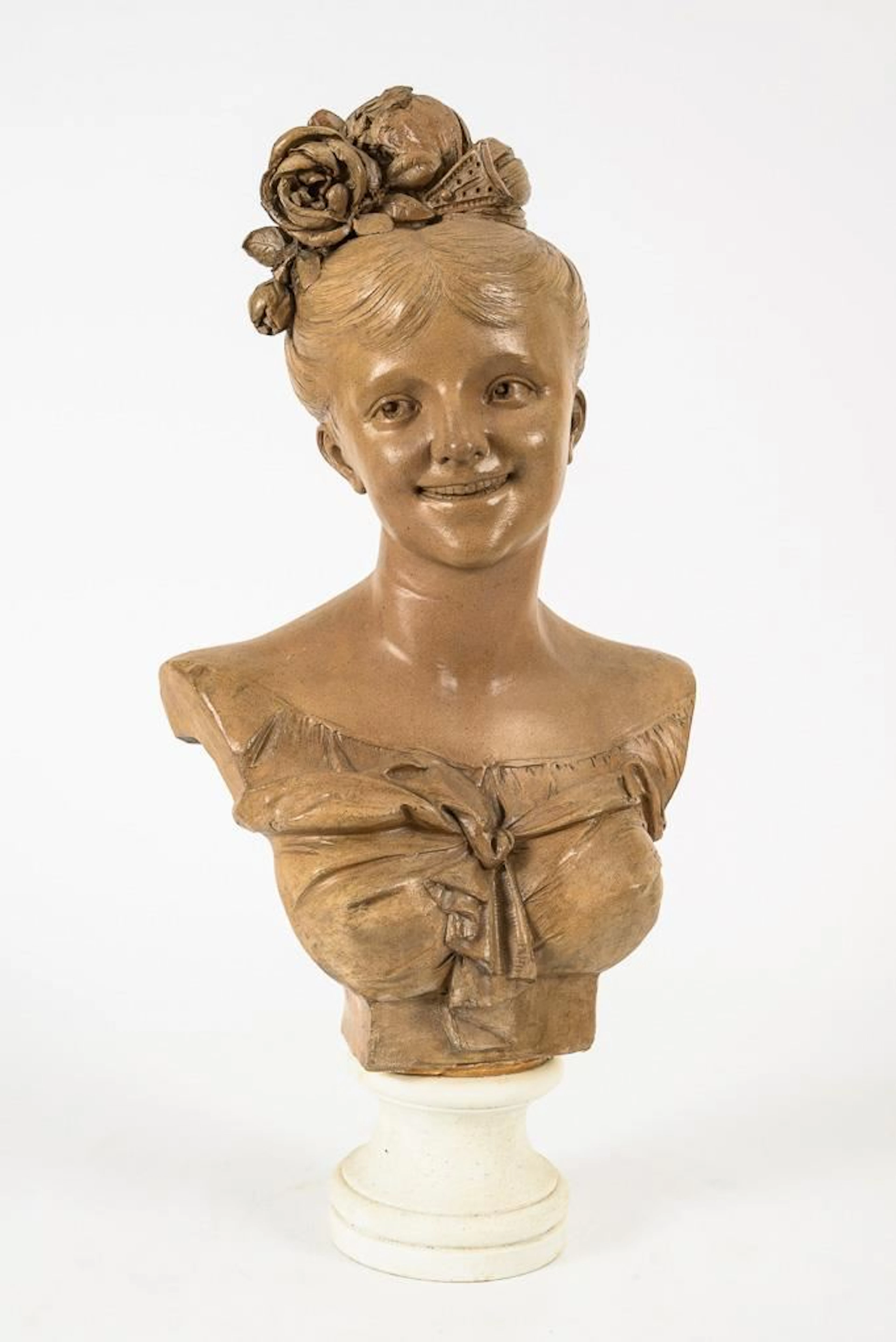 Bust of a girl with a rose in her hair.