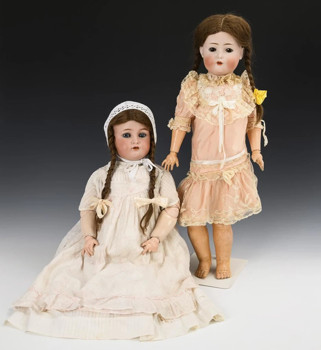 2 porcelain-headed girls with braids.