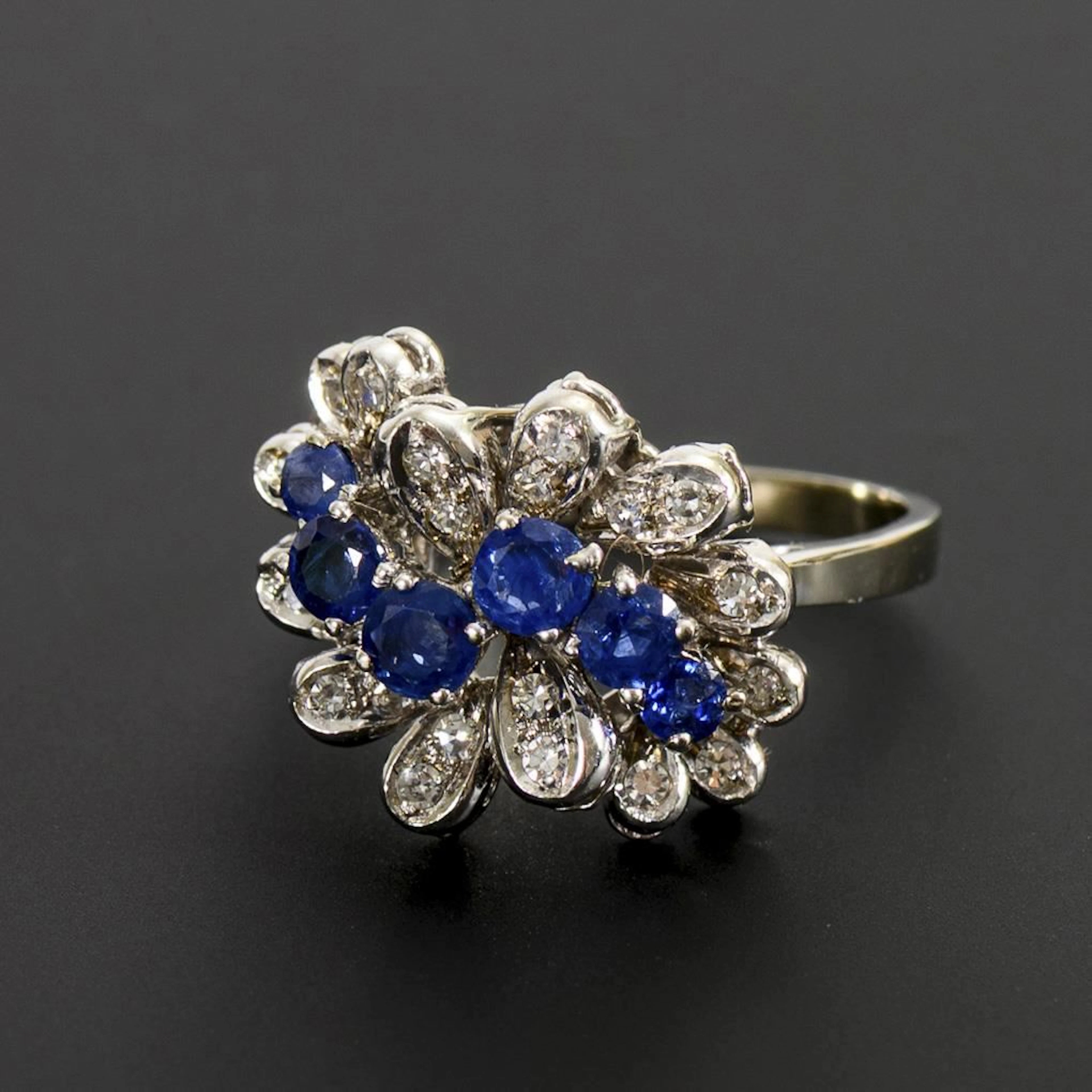 Modern ring with blue gemstones, likely sapphires, and diamonds.